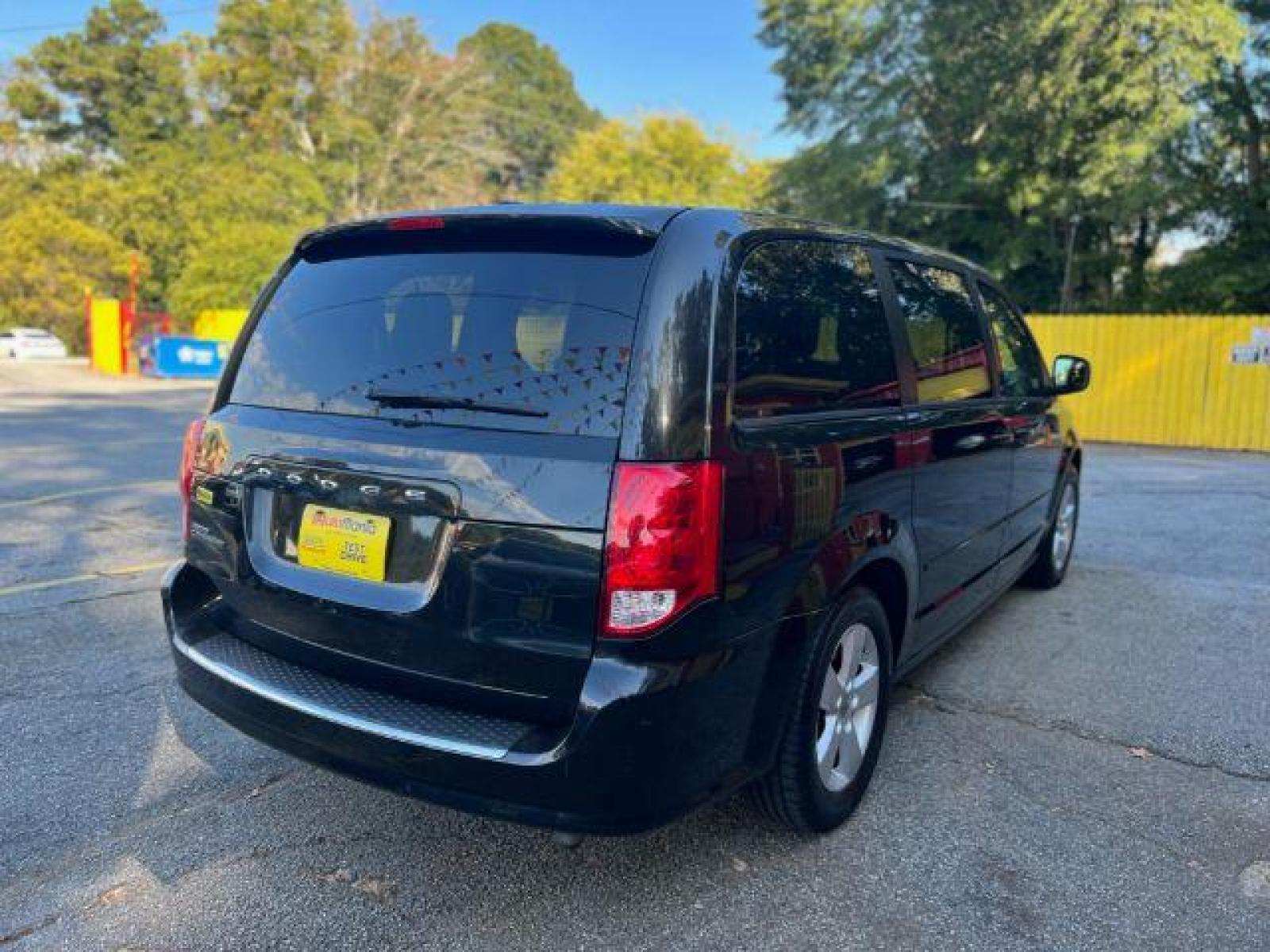 2013 Black Dodge Grand Caravan SE (2C4RDGBG3DR) with an 3.6L V6 DOHC 24V engine, 6-Speed Automatic transmission, located at 1806 Veterans Memorial Hwy SW, Austell, GA, 30168, (770) 944-9558, 33.817959, -84.606987 - Photo #3