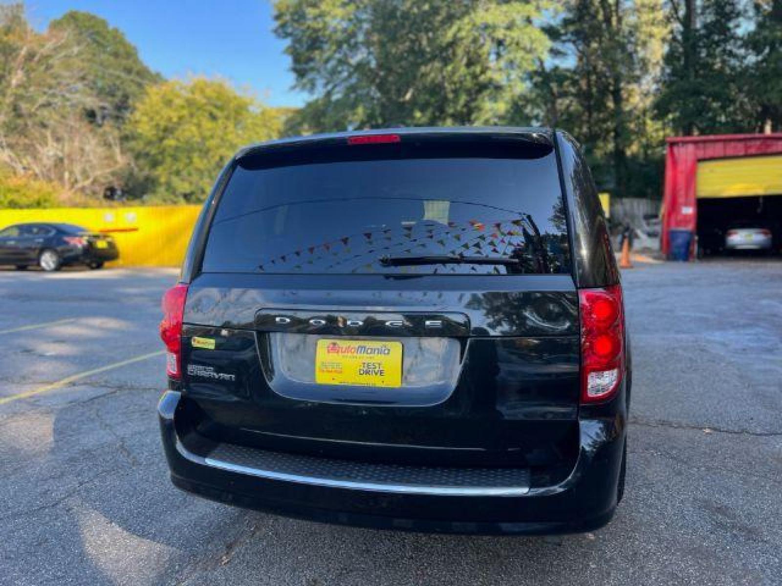 2013 Black Dodge Grand Caravan SE (2C4RDGBG3DR) with an 3.6L V6 DOHC 24V engine, 6-Speed Automatic transmission, located at 1806 Veterans Memorial Hwy SW, Austell, GA, 30168, (770) 944-9558, 33.817959, -84.606987 - Photo #4