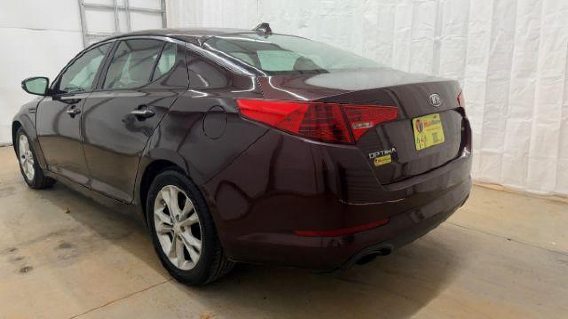 2012 Maroon Kia Optima LX AT (5XXGM4A74CG) with an 2.4L L4 DOHC 16V engine, 6-Speed Automatic transmission, located at 1806 Veterans Memorial Hwy SW, Austell, GA, 30168, (770) 944-9558, 33.817959, -84.606987 - Photo#3