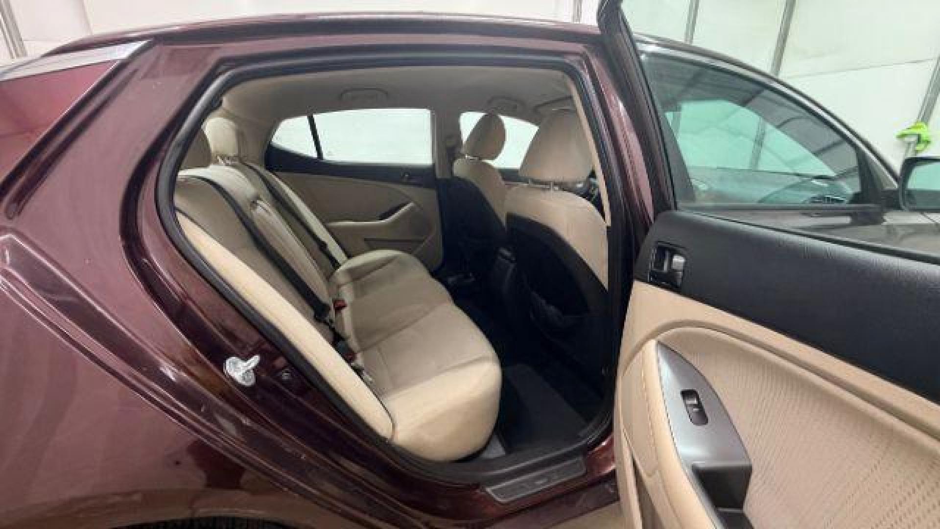 2012 Maroon Kia Optima LX AT (5XXGM4A74CG) with an 2.4L L4 DOHC 16V engine, 6-Speed Automatic transmission, located at 1806 Veterans Memorial Hwy SW, Austell, GA, 30168, (770) 944-9558, 33.817959, -84.606987 - Photo#16