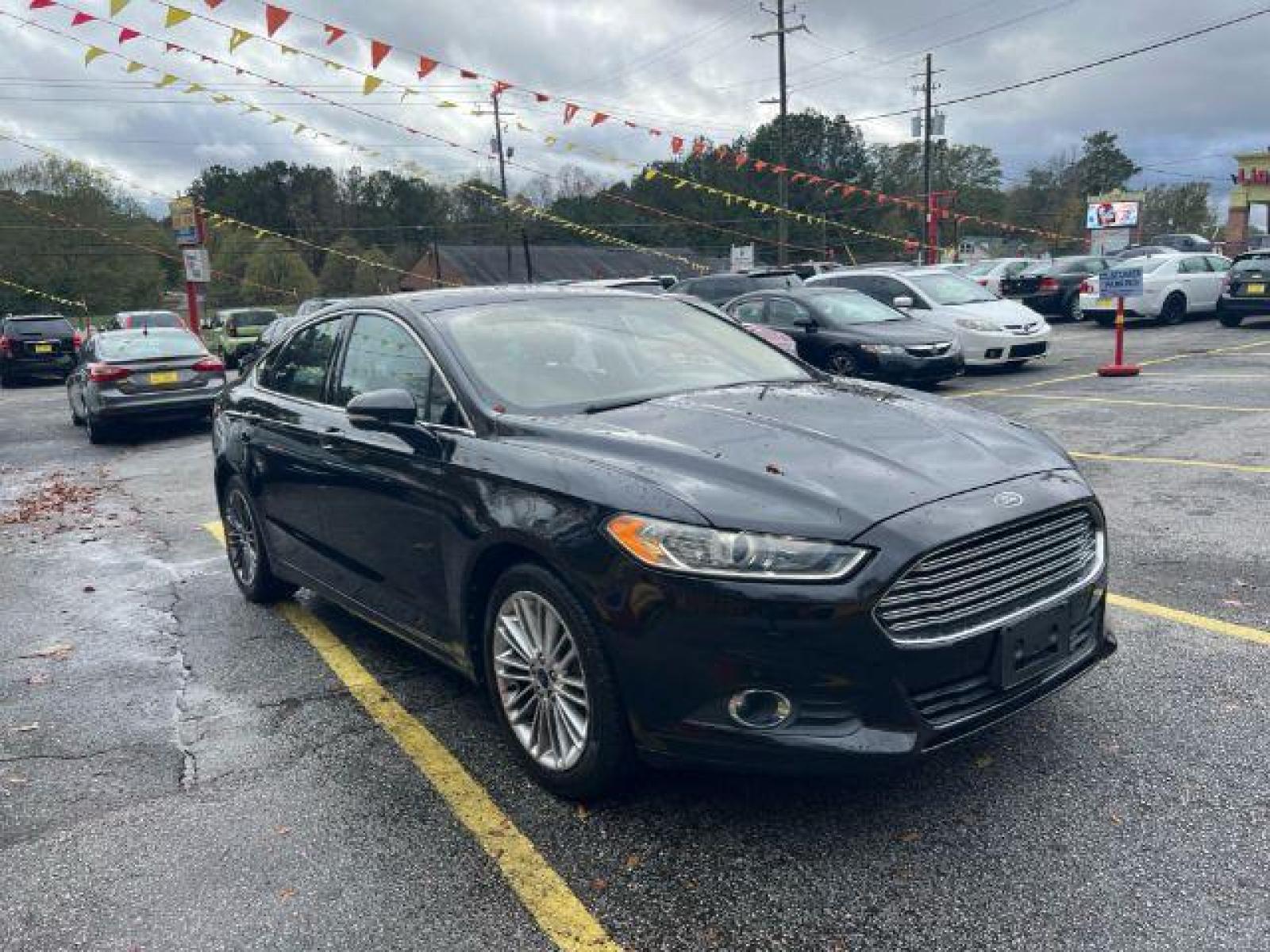 2013 Black Ford Fusion SE (3FA6P0HR9DR) with an 1.6L L4 DOHC 16V engine, located at 1806 Veterans Memorial Hwy SW, Austell, GA, 30168, (770) 944-9558, 33.817959, -84.606987 - Photo #2
