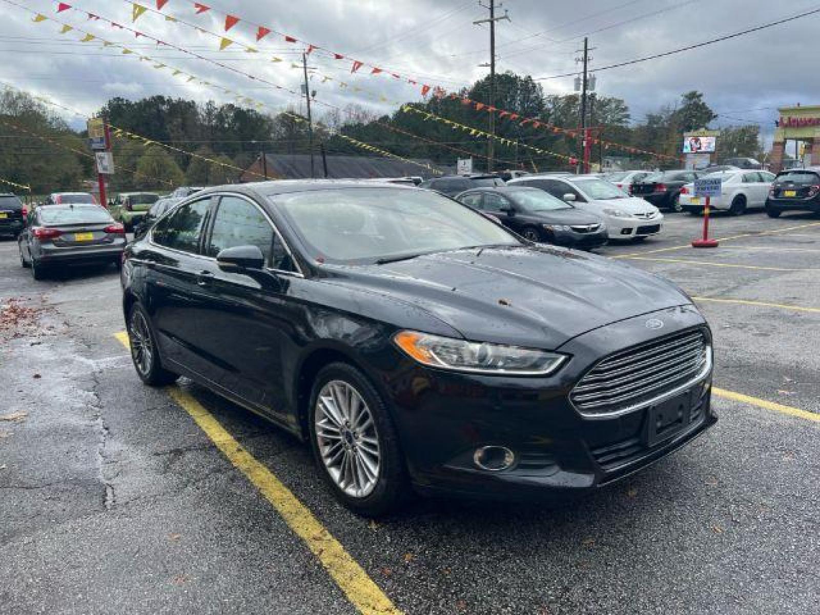 2013 Black Ford Fusion SE (3FA6P0HR9DR) with an 1.6L L4 DOHC 16V engine, located at 1806 Veterans Memorial Hwy SW, Austell, GA, 30168, (770) 944-9558, 33.817959, -84.606987 - Photo #3