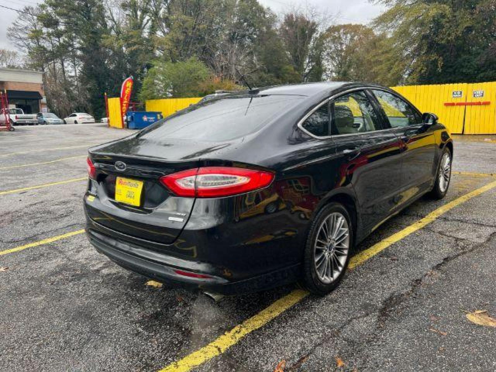 2013 Black Ford Fusion SE (3FA6P0HR9DR) with an 1.6L L4 DOHC 16V engine, located at 1806 Veterans Memorial Hwy SW, Austell, GA, 30168, (770) 944-9558, 33.817959, -84.606987 - Photo #4