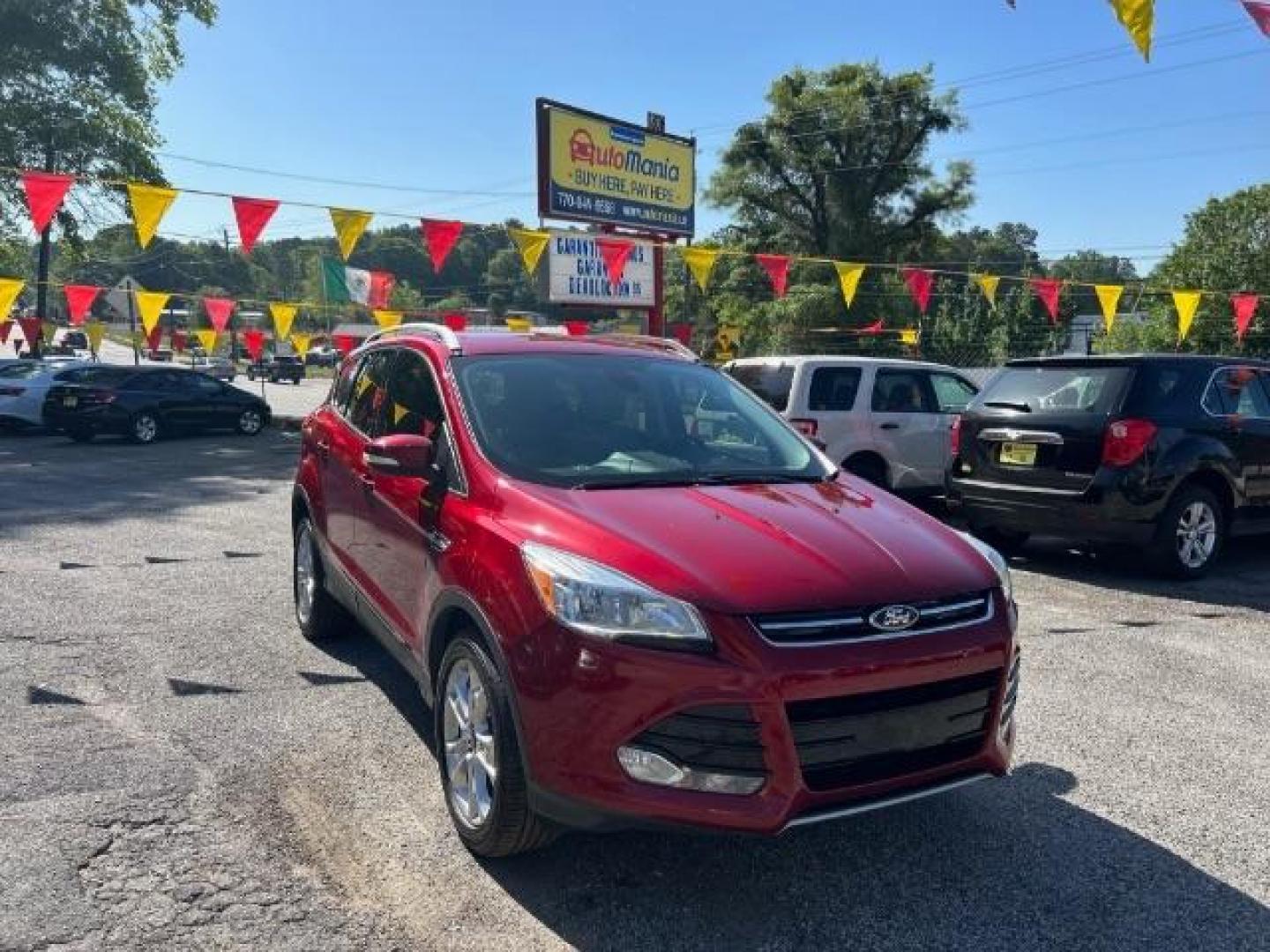 2014 Red Ford Escape Titanium FWD (1FMCU0JXXEU) with an 1.6L L4 DOHC 16V engine, 6-Speed Automatic transmission, located at 1806 Veterans Memorial Hwy SW, Austell, GA, 30168, (770) 944-9558, 33.817959, -84.606987 - Photo#0