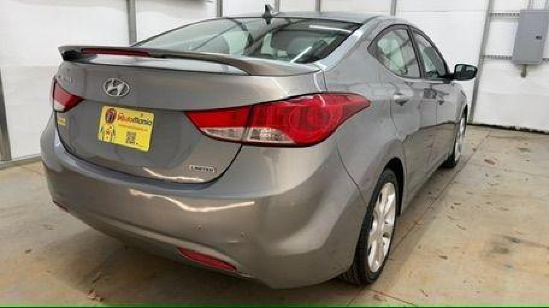 2013 Silver Hyundai Elantra Limited (KMHDH4AE4DU) with an 1.8L L4 DOHC 16V engine, 6-Speed Automatic transmission, located at 1806 Veterans Memorial Hwy SW, Austell, GA, 30168, (770) 944-9558, 33.817959, -84.606987 - Photo#5