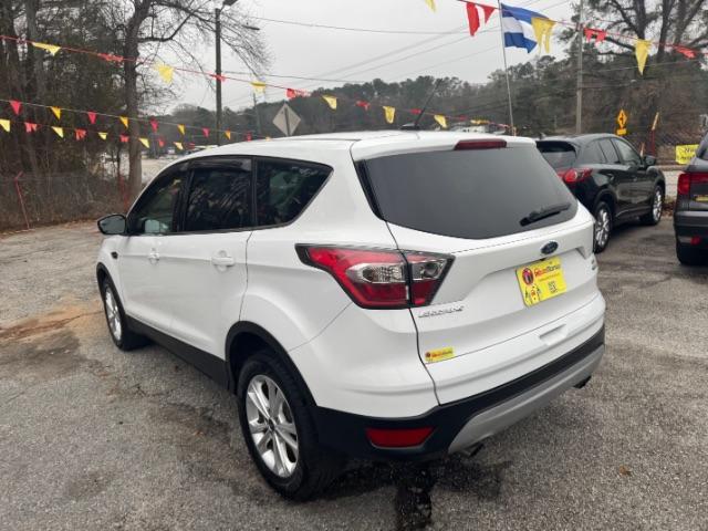 2017 White Ford Escape SE FWD (1FMCU0GD2HU) with an 1.5L L4 DOHC 16V engine, 6-Speed Automatic transmission, located at 1806 Veterans Memorial Hwy SW, Austell, GA, 30168, (770) 944-9558, 33.817959, -84.606987 - Photo#5