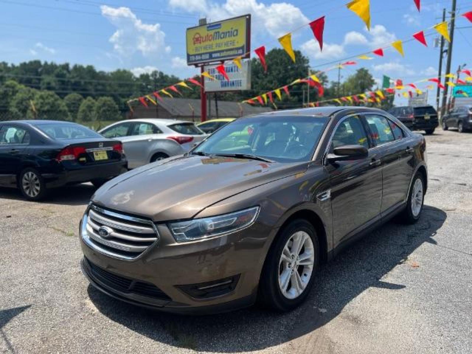 2015 BROWN Ford Taurus SEL FWD (1FAHP2E88FG) with an 3.5L V6 DOHC 24V engine, 6-Speed Automatic transmission, located at 1806 Veterans Memorial Hwy SW, Austell, GA, 30168, (770) 944-9558, 33.817959, -84.606987 - Photo #0