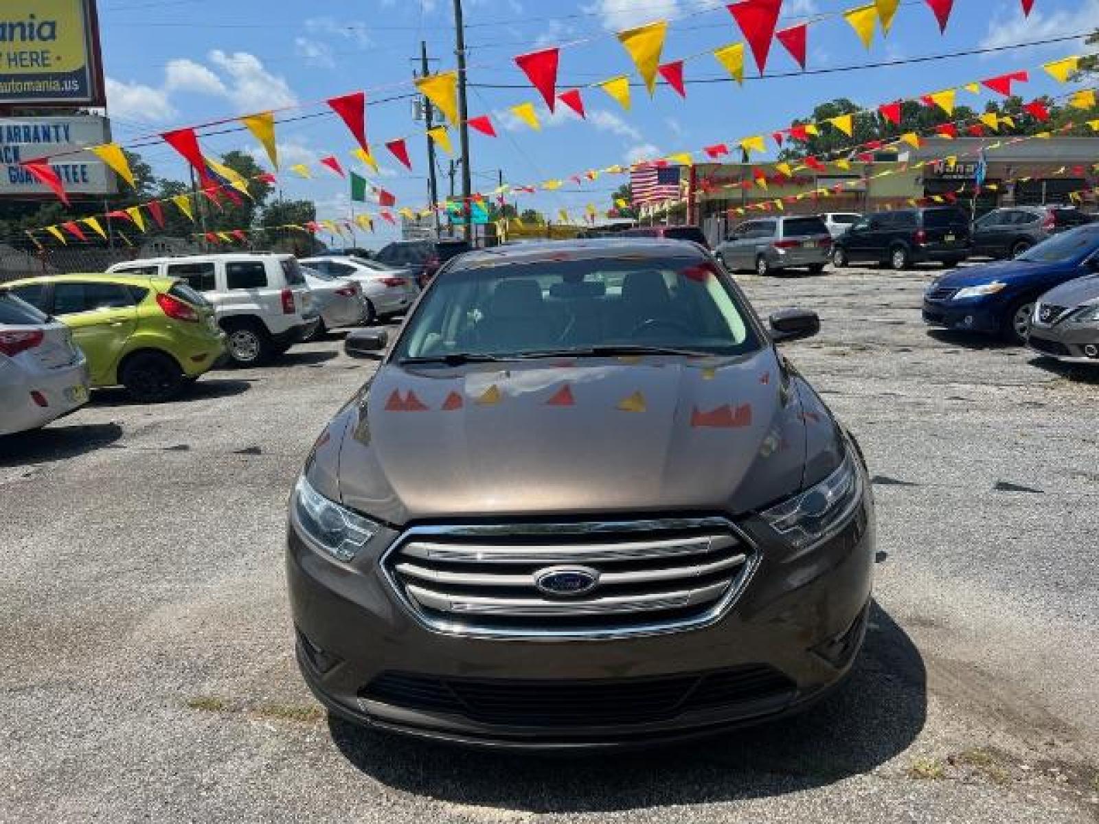2015 BROWN Ford Taurus SEL FWD (1FAHP2E88FG) with an 3.5L V6 DOHC 24V engine, 6-Speed Automatic transmission, located at 1806 Veterans Memorial Hwy SW, Austell, GA, 30168, (770) 944-9558, 33.817959, -84.606987 - Photo #1