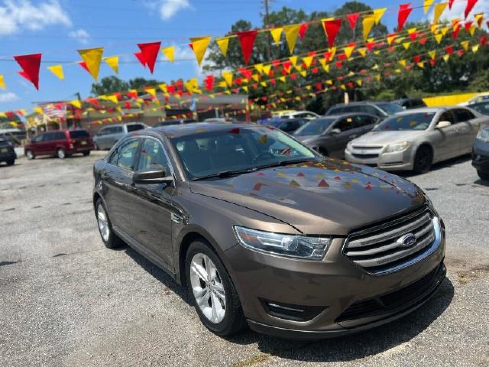 2015 BROWN Ford Taurus SEL FWD (1FAHP2E88FG) with an 3.5L V6 DOHC 24V engine, 6-Speed Automatic transmission, located at 1806 Veterans Memorial Hwy SW, Austell, GA, 30168, (770) 944-9558, 33.817959, -84.606987 - Photo #2