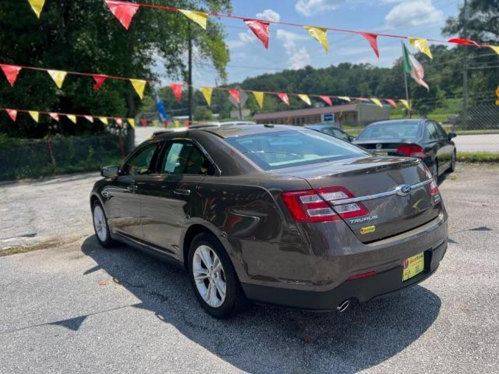 2015 BROWN Ford Taurus SEL FWD (1FAHP2E88FG) with an 3.5L V6 DOHC 24V engine, 6-Speed Automatic transmission, located at 1806 Veterans Memorial Hwy SW, Austell, GA, 30168, (770) 944-9558, 33.817959, -84.606987 - Photo #5