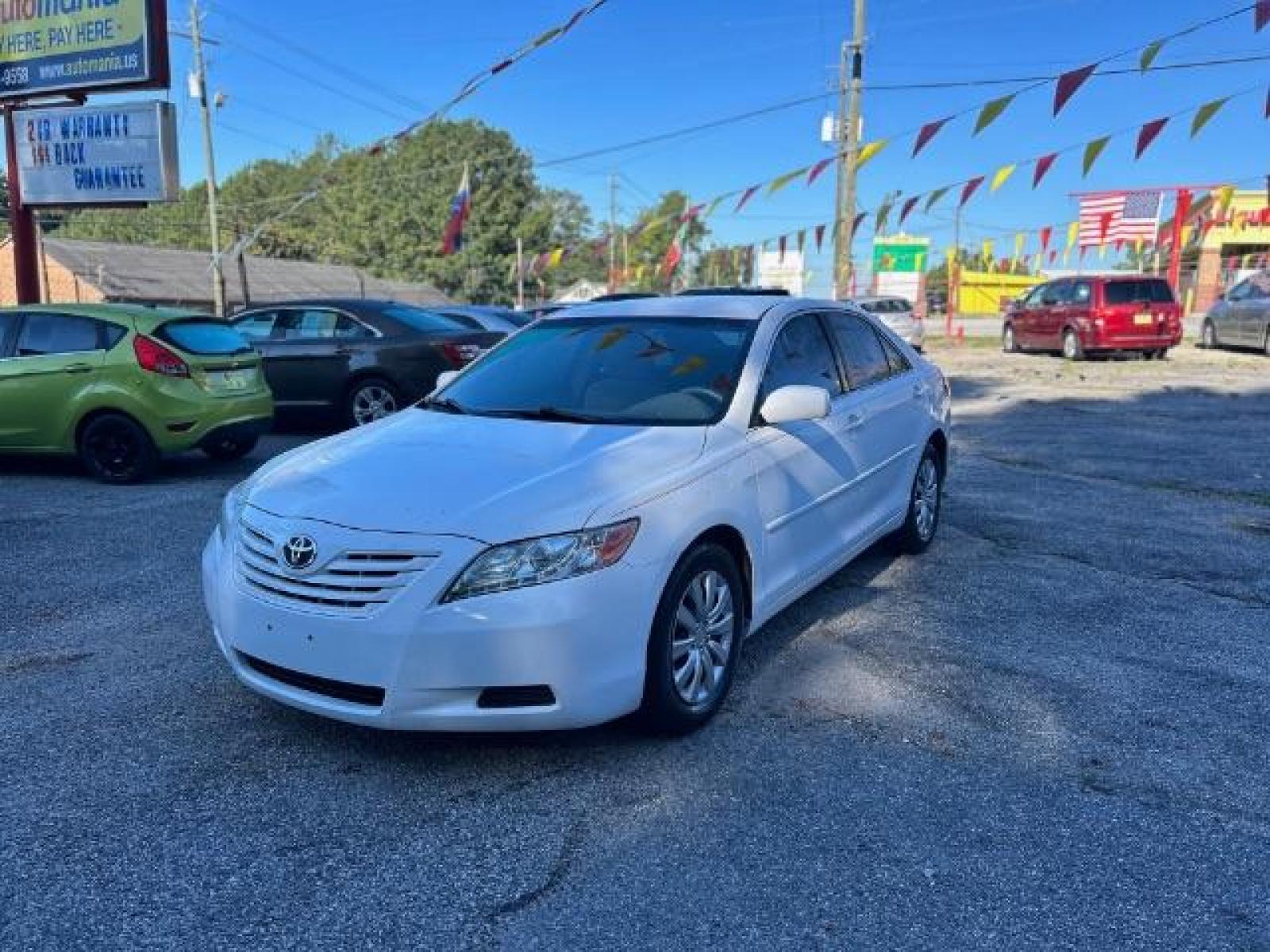2009 White Toyota Camry LE 5-Spd AT (4T1BE46KX9U) with an 2.4L L4 DOHC 16V engine, 5-Speed Automatic transmission, located at 1806 Veterans Memorial Hwy SW, Austell, GA, 30168, (770) 944-9558, 33.817959, -84.606987 - Photo #0