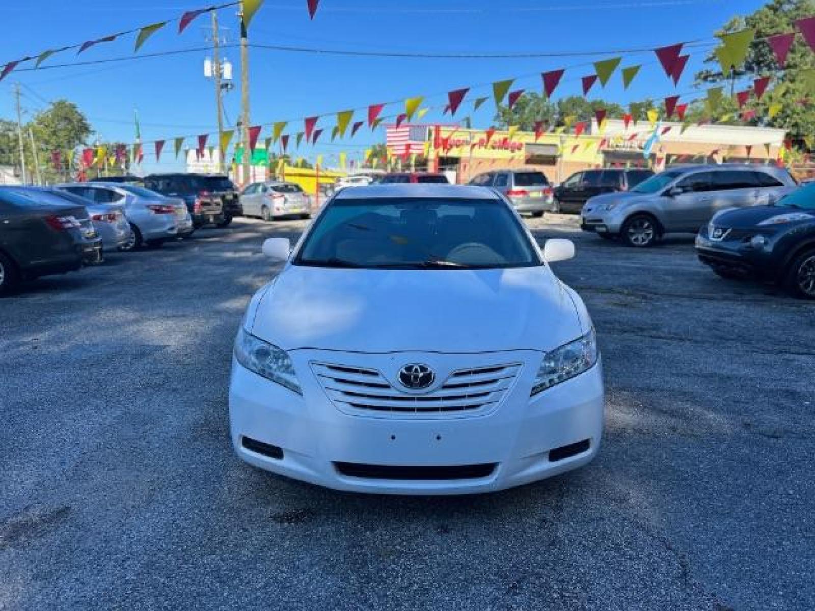 2009 White Toyota Camry LE 5-Spd AT (4T1BE46KX9U) with an 2.4L L4 DOHC 16V engine, 5-Speed Automatic transmission, located at 1806 Veterans Memorial Hwy SW, Austell, GA, 30168, (770) 944-9558, 33.817959, -84.606987 - Photo #1
