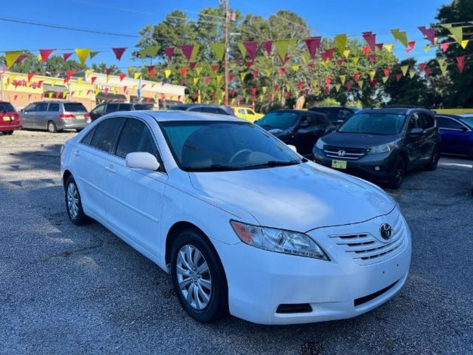 2009 White Toyota Camry LE 5-Spd AT (4T1BE46KX9U) with an 2.4L L4 DOHC 16V engine, 5-Speed Automatic transmission, located at 1806 Veterans Memorial Hwy SW, Austell, GA, 30168, (770) 944-9558, 33.817959, -84.606987 - Photo #2
