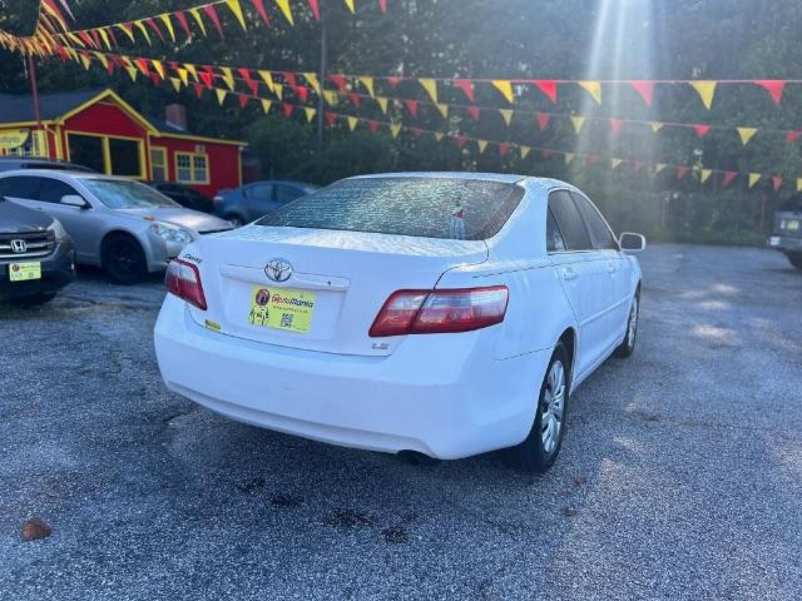 2009 White Toyota Camry LE 5-Spd AT (4T1BE46KX9U) with an 2.4L L4 DOHC 16V engine, 5-Speed Automatic transmission, located at 1806 Veterans Memorial Hwy SW, Austell, GA, 30168, (770) 944-9558, 33.817959, -84.606987 - Photo #3