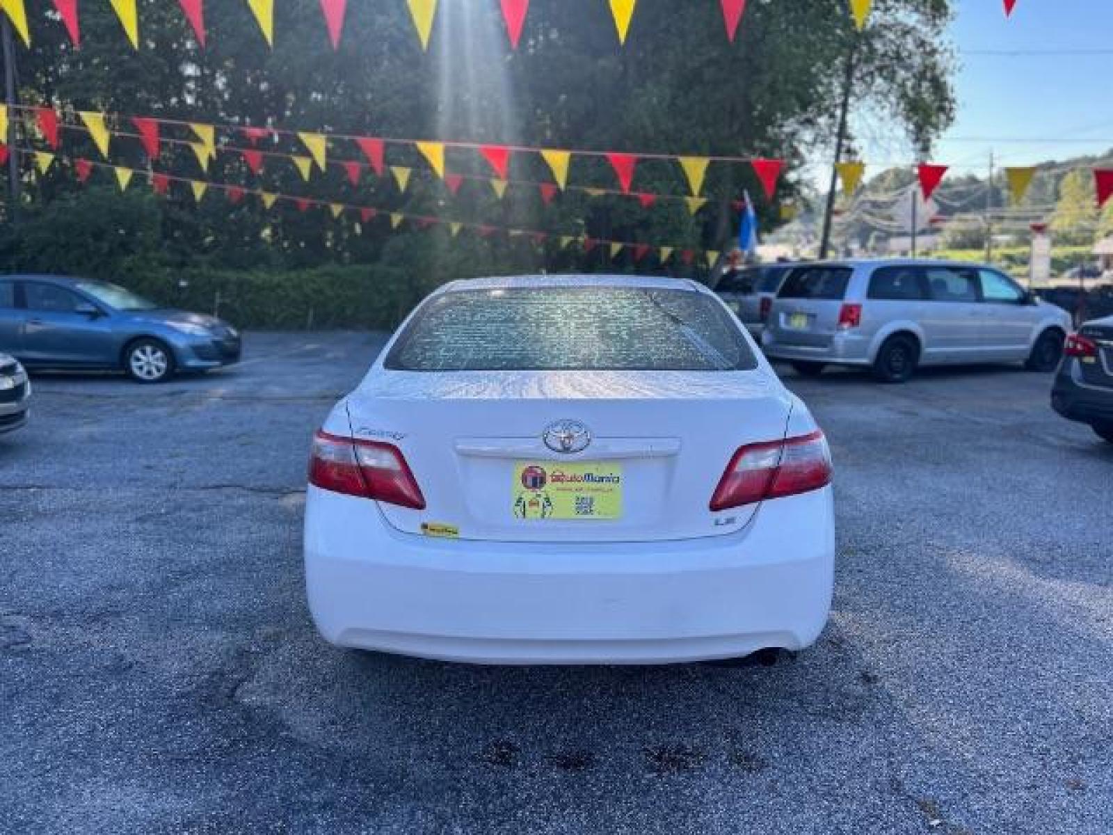 2009 White Toyota Camry LE 5-Spd AT (4T1BE46KX9U) with an 2.4L L4 DOHC 16V engine, 5-Speed Automatic transmission, located at 1806 Veterans Memorial Hwy SW, Austell, GA, 30168, (770) 944-9558, 33.817959, -84.606987 - Photo #4