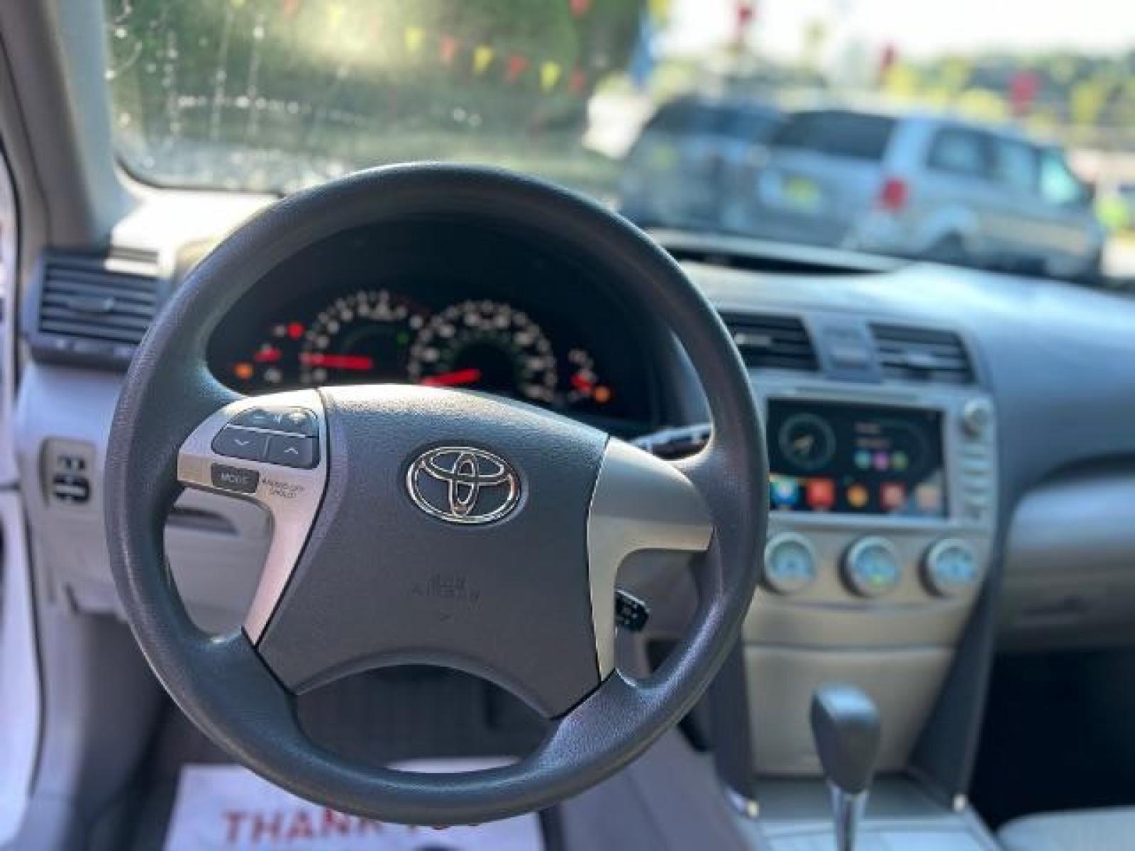 2009 White Toyota Camry LE 5-Spd AT (4T1BE46KX9U) with an 2.4L L4 DOHC 16V engine, 5-Speed Automatic transmission, located at 1806 Veterans Memorial Hwy SW, Austell, GA, 30168, (770) 944-9558, 33.817959, -84.606987 - Photo #8