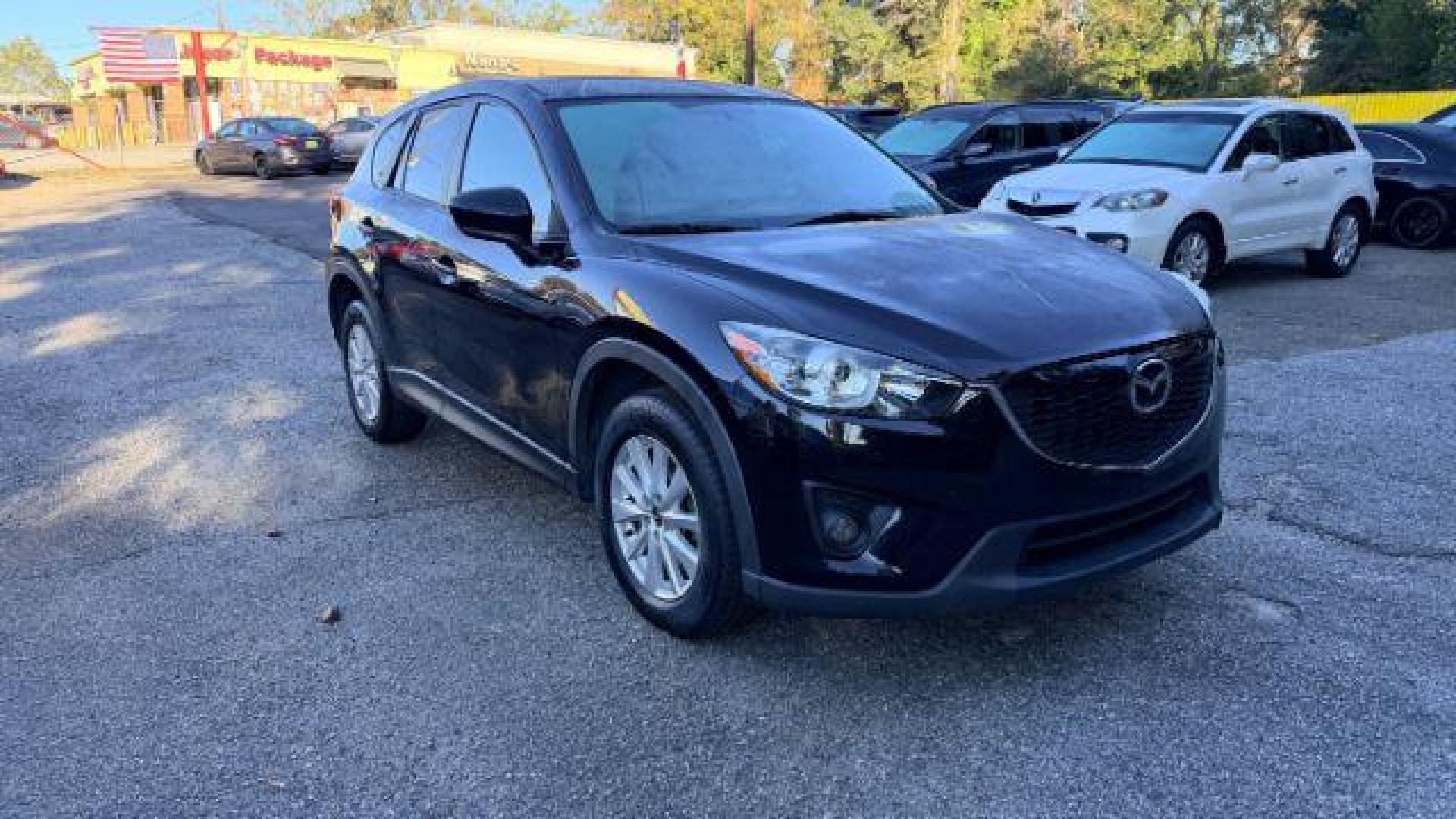2014 Black Mazda CX-5 Touring (JM3KE2CY3E0) with an 2.5L L4 DOHC 16V engine, 6-Speed Automatic transmission, located at 1806 Veterans Memorial Hwy SW, Austell, GA, 30168, (770) 944-9558, 33.817959, -84.606987 - Photo#2