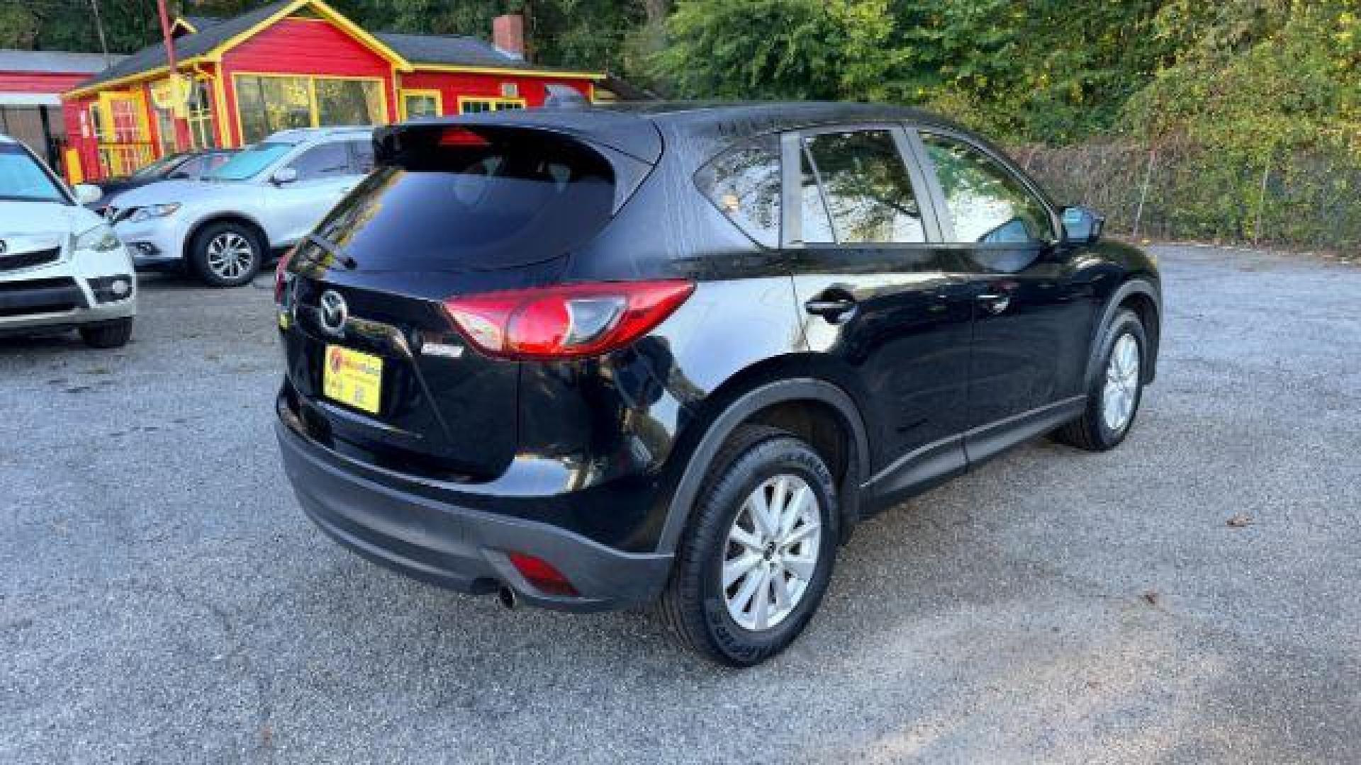 2014 Black Mazda CX-5 Touring (JM3KE2CY3E0) with an 2.5L L4 DOHC 16V engine, 6-Speed Automatic transmission, located at 1806 Veterans Memorial Hwy SW, Austell, GA, 30168, (770) 944-9558, 33.817959, -84.606987 - Photo#3