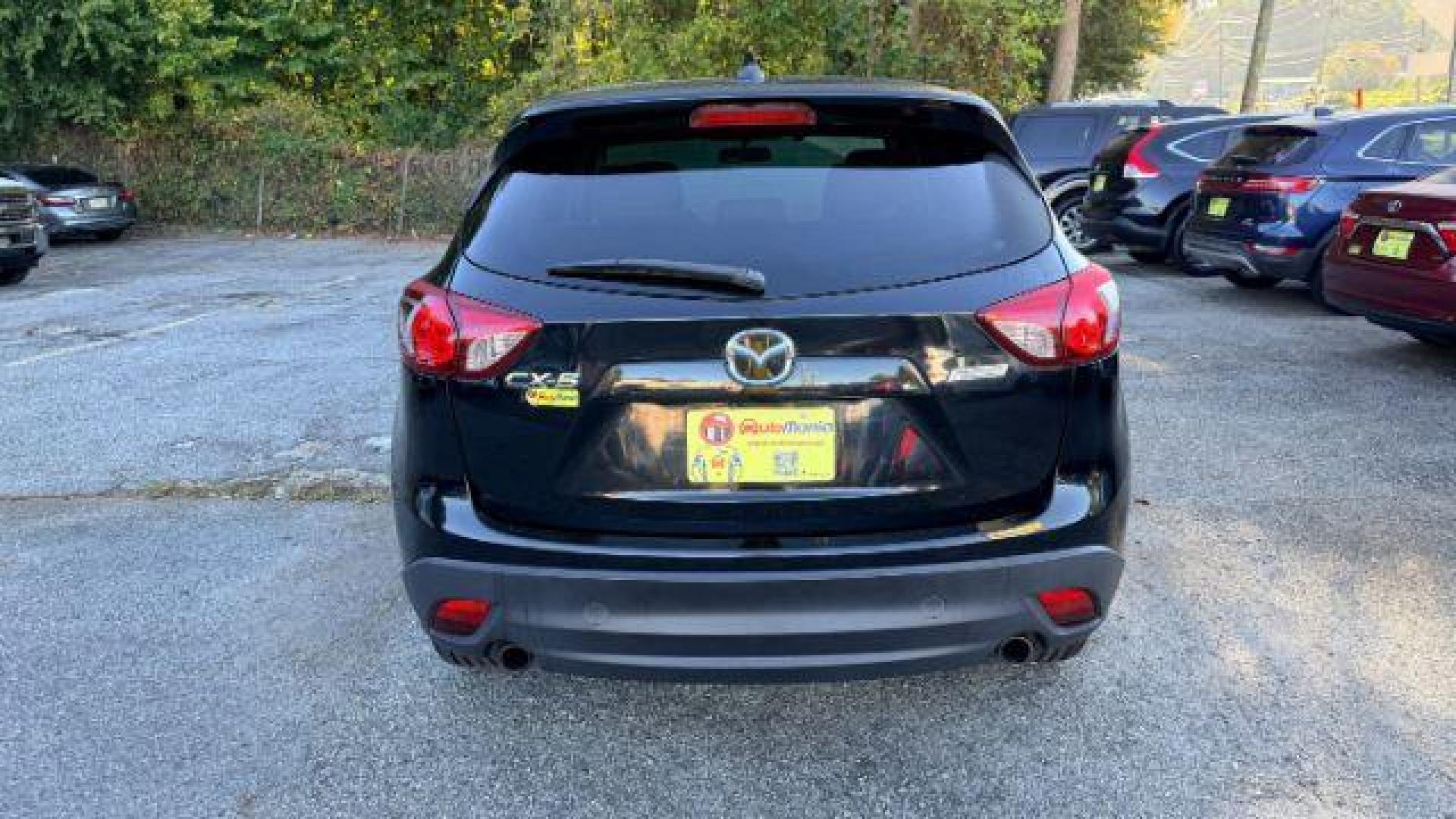 2014 Black Mazda CX-5 Touring (JM3KE2CY3E0) with an 2.5L L4 DOHC 16V engine, 6-Speed Automatic transmission, located at 1806 Veterans Memorial Hwy SW, Austell, GA, 30168, (770) 944-9558, 33.817959, -84.606987 - Photo#4