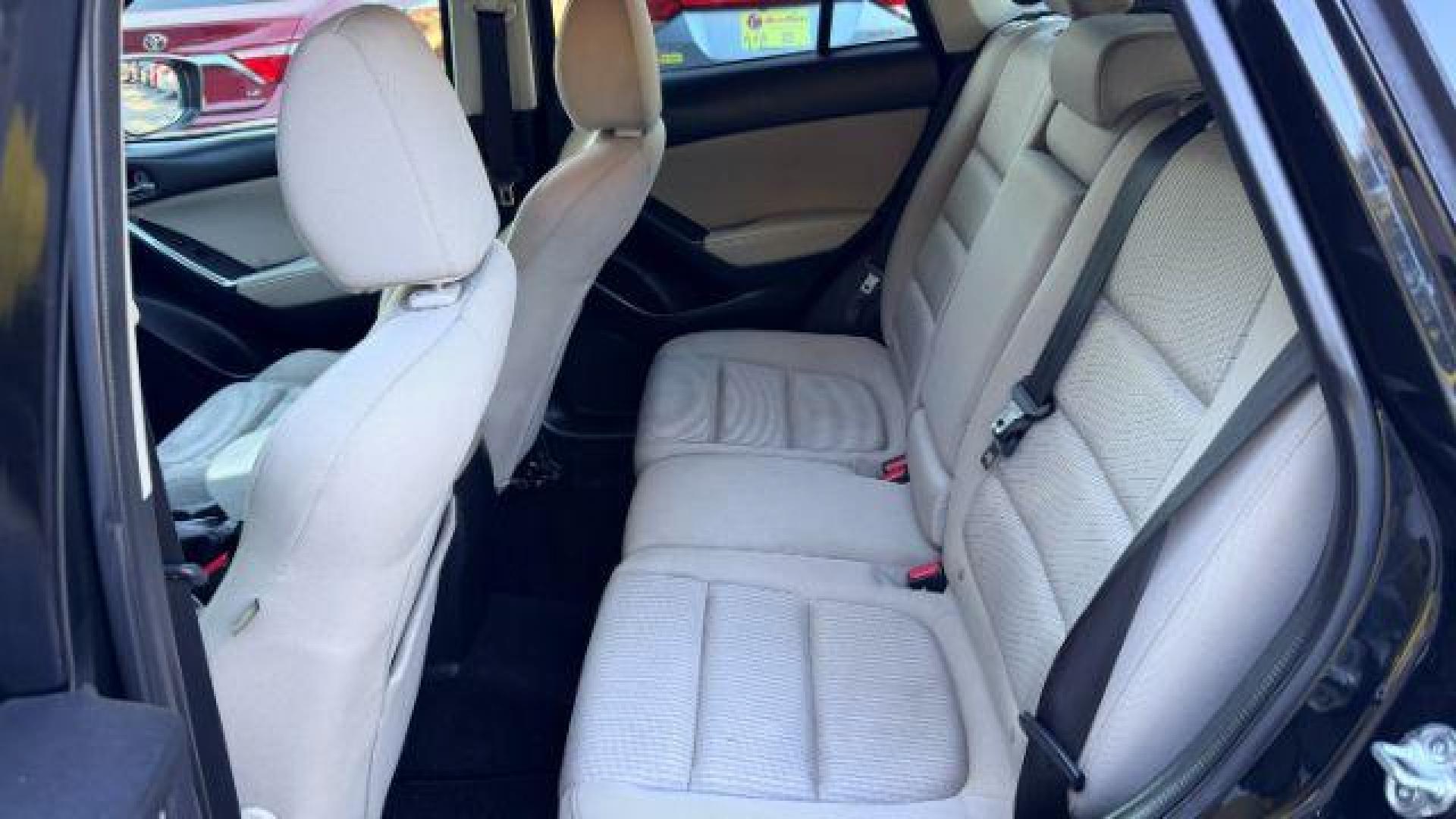 2014 Black Mazda CX-5 Touring (JM3KE2CY3E0) with an 2.5L L4 DOHC 16V engine, 6-Speed Automatic transmission, located at 1806 Veterans Memorial Hwy SW, Austell, GA, 30168, (770) 944-9558, 33.817959, -84.606987 - Photo#7