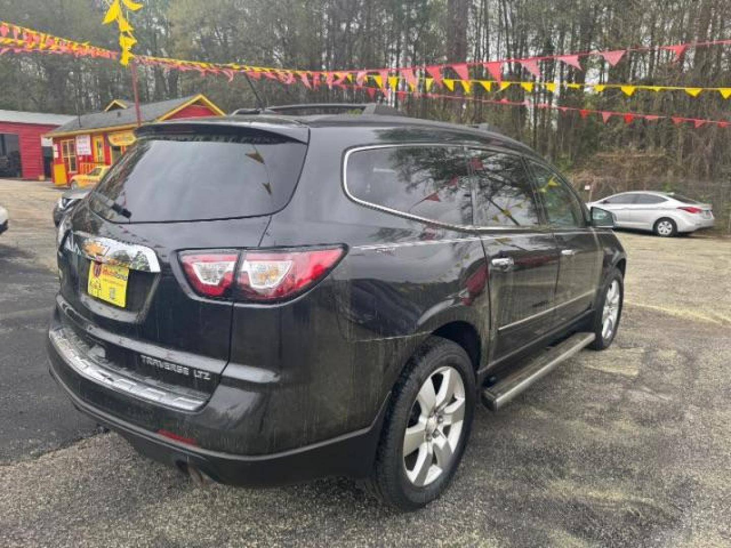 2013 BLACK Chevrolet Traverse LTZ FWD (1GNKRLKD1DJ) with an 3.6L V6 DOHC 24V engine, 6-Speed Automatic transmission, located at 1806 Veterans Memorial Hwy SW, Austell, GA, 30168, (770) 944-9558, 33.817959, -84.606987 - Photo#3
