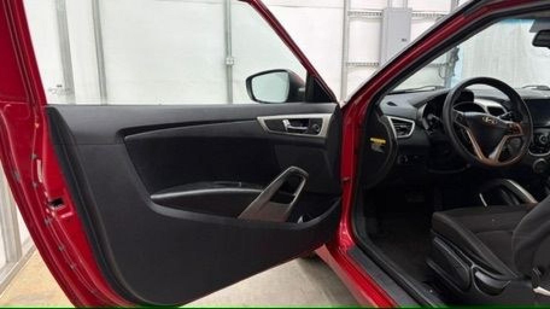 2013 Red Hyundai Veloster Base (KMHTC6ADXDU) with an 1.6L L4 DOHC 16V engine, 6-Speed Automatic transmission, located at 1806 Veterans Memorial Hwy SW, Austell, GA, 30168, (770) 944-9558, 33.817959, -84.606987 - This Veloster is in great overall condition and very clean inside, with a great-looking interior. The driver's seat has a small hole, and the exterior has a few cosmetic scratches, including a small one on the right side door a sporty, head-turning coupe with unique styling.- Photo#9