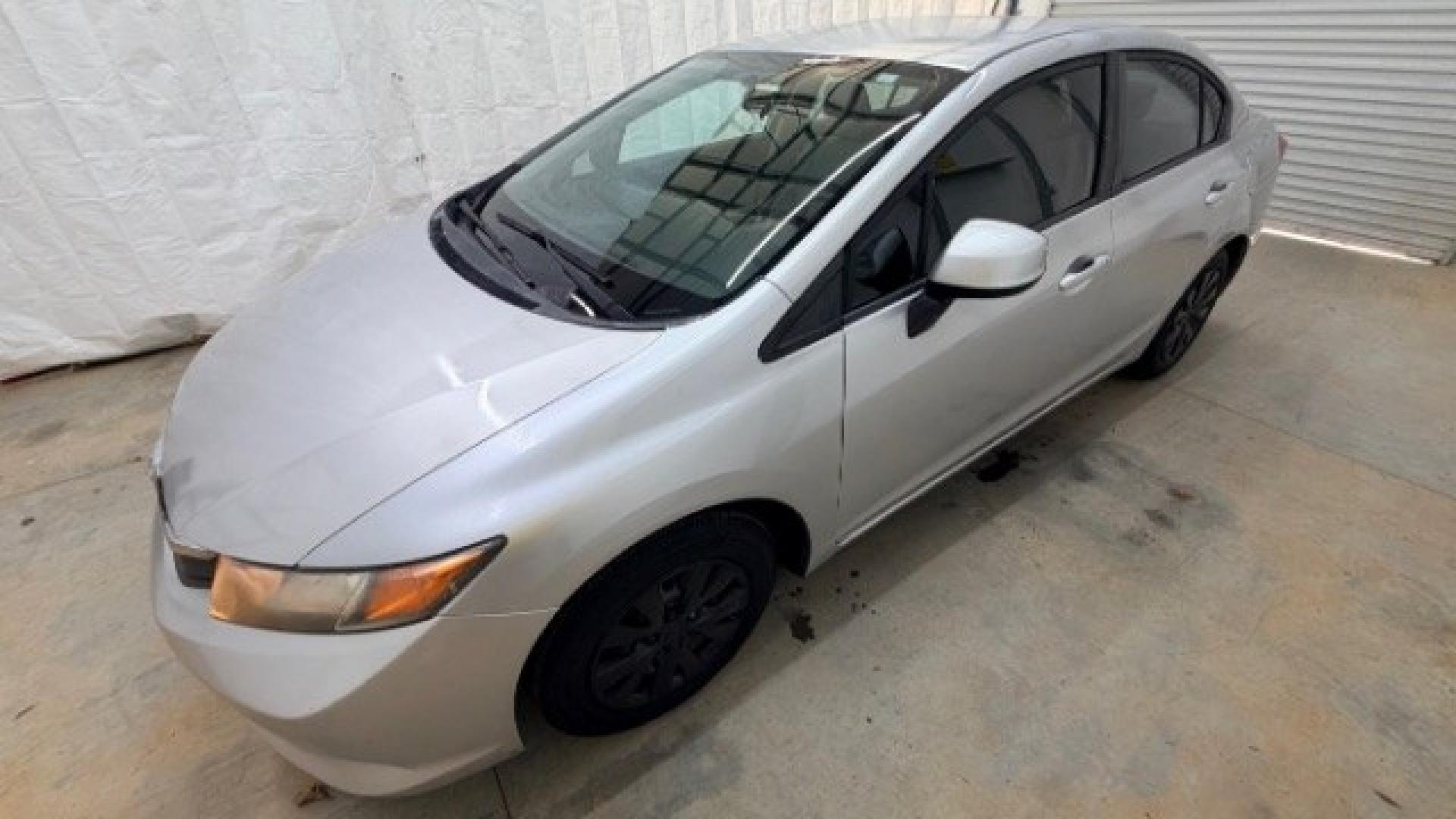 2012 Silver Honda Civic LX Sedan 5-Speed AT (2HGFB2F55CH) with an 1.8L L4 SOHC 16V engine, 5-Speed Automatic transmission, located at 1806 Veterans Memorial Hwy SW, Austell, GA, 30168, (770) 944-9558, 33.817959, -84.606987 - Photo#1