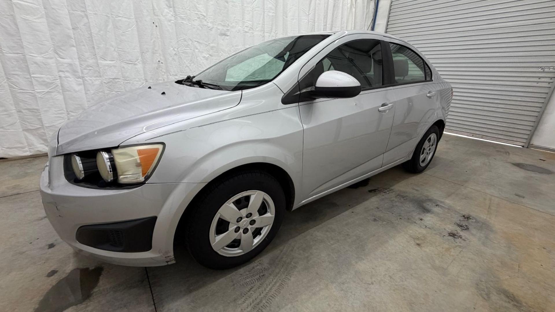 2015 Silver Chevrolet Sonic LS Auto Sedan (1G1JA5SH0F4) with an 1.8L L4 DOHC 24V engine, 6-Speed Automatic transmission, located at 1806 Veterans Memorial Hwy SW, Austell, GA, 30168, (770) 944-9558, 33.817959, -84.606987 - Photo#1