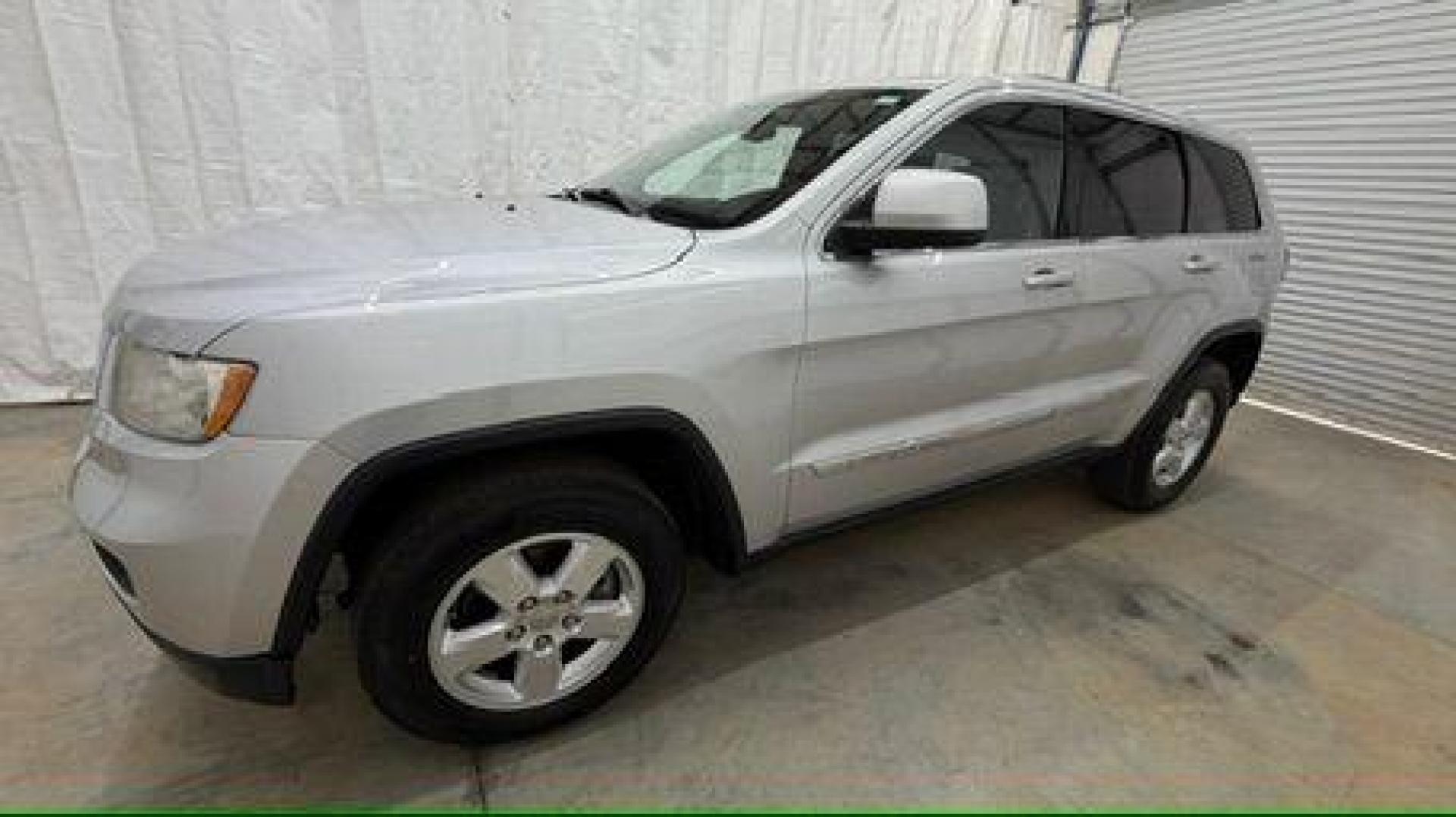 2012 Silver Jeep Grand Cherokee Laredo 2WD (1C4RJEAG6CC) with an 3.6L V6 DOHC 24V engine, 5-Speed Automatic transmission, located at 1806 Veterans Memorial Hwy SW, Austell, GA, 30168, (770) 944-9558, 33.817959, -84.606987 - Photo#1