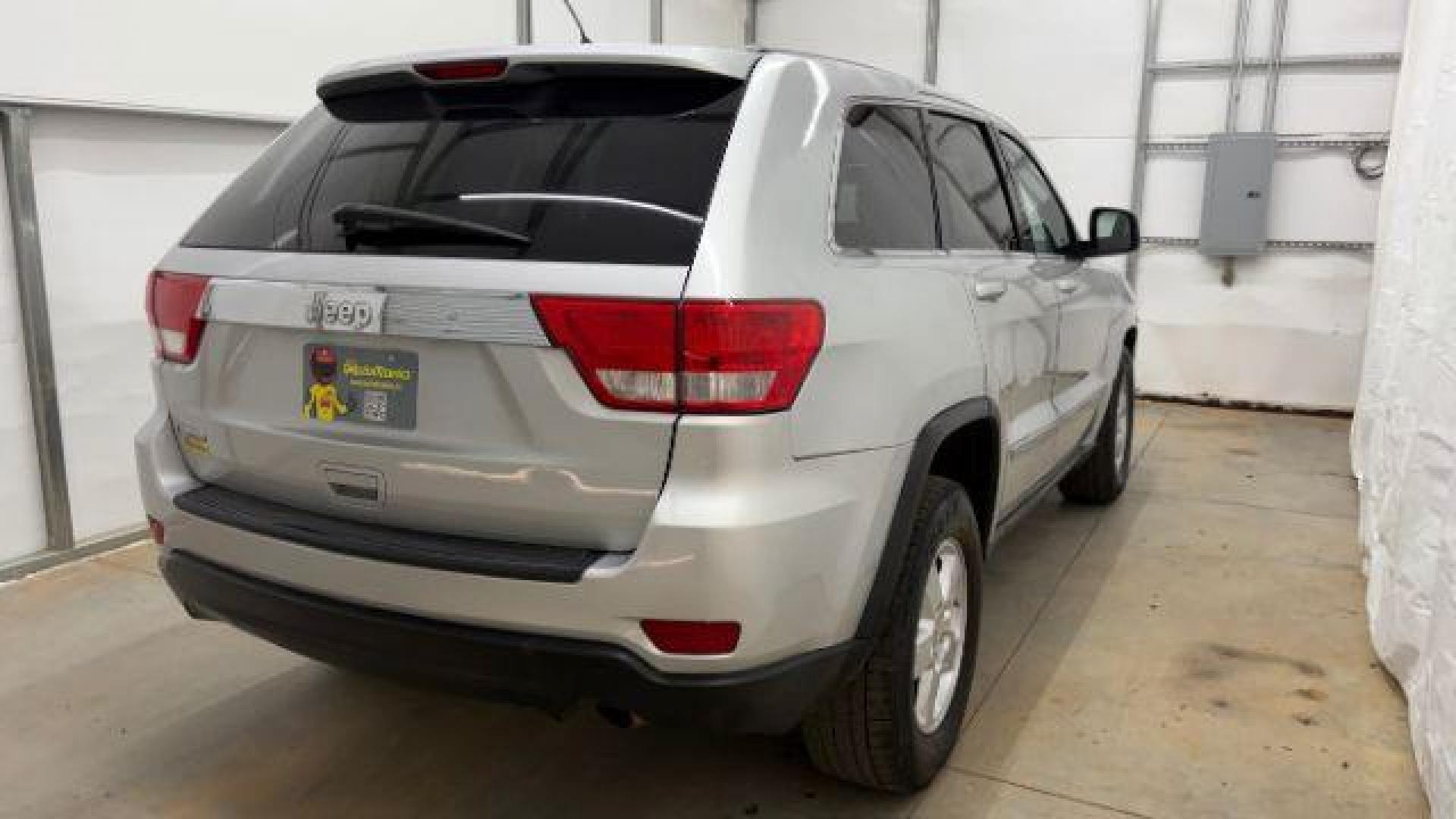 2012 Silver Jeep Grand Cherokee Laredo 2WD (1C4RJEAG6CC) with an 3.6L V6 DOHC 24V engine, 5-Speed Automatic transmission, located at 1806 Veterans Memorial Hwy SW, Austell, GA, 30168, (770) 944-9558, 33.817959, -84.606987 - Photo#5
