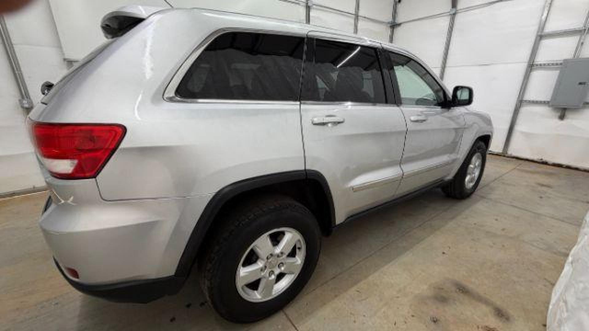 2012 Silver Jeep Grand Cherokee Laredo 2WD (1C4RJEAG6CC) with an 3.6L V6 DOHC 24V engine, 5-Speed Automatic transmission, located at 1806 Veterans Memorial Hwy SW, Austell, GA, 30168, (770) 944-9558, 33.817959, -84.606987 - Photo#6