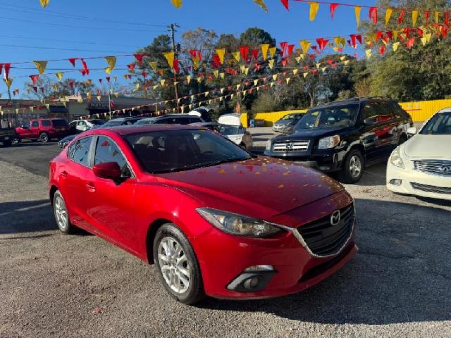 2015 Red Mazda MAZDA3 i Grand Touring AT 4-Door (3MZBM1W76FM) with an 2.0L L4 DOHC 16V engine, 6-Speed Automatic transmission, located at 1806 Veterans Memorial Hwy SW, Austell, GA, 30168, (770) 944-9558, 33.817959, -84.606987 - Photo#1