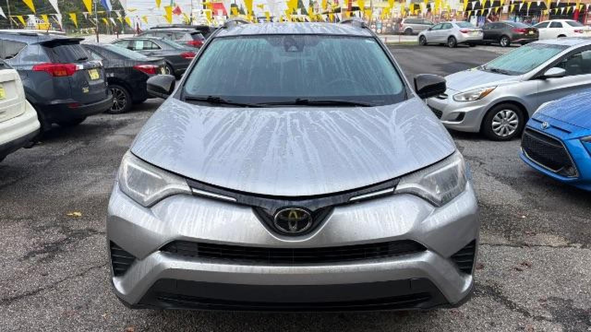 2018 Silver Toyota RAV4 LE FWD (2T3ZFREV3JW) with an 2.5L L4 DOHC 16V engine, 6-Speed Automatic transmission, located at 1806 Veterans Memorial Hwy SW, Austell, GA, 30168, (770) 944-9558, 33.817959, -84.606987 - Photo#1