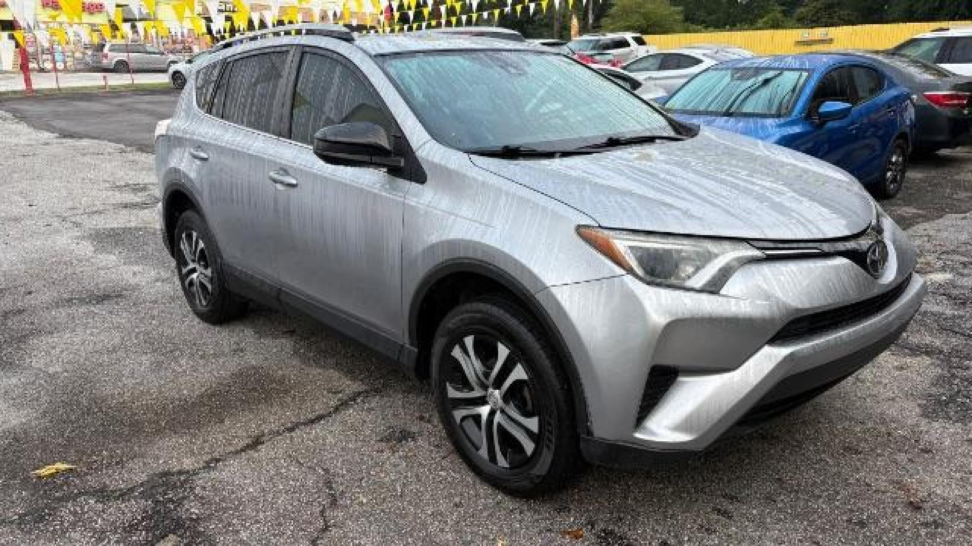 2018 Silver Toyota RAV4 LE FWD (2T3ZFREV3JW) with an 2.5L L4 DOHC 16V engine, 6-Speed Automatic transmission, located at 1806 Veterans Memorial Hwy SW, Austell, GA, 30168, (770) 944-9558, 33.817959, -84.606987 - Photo#2