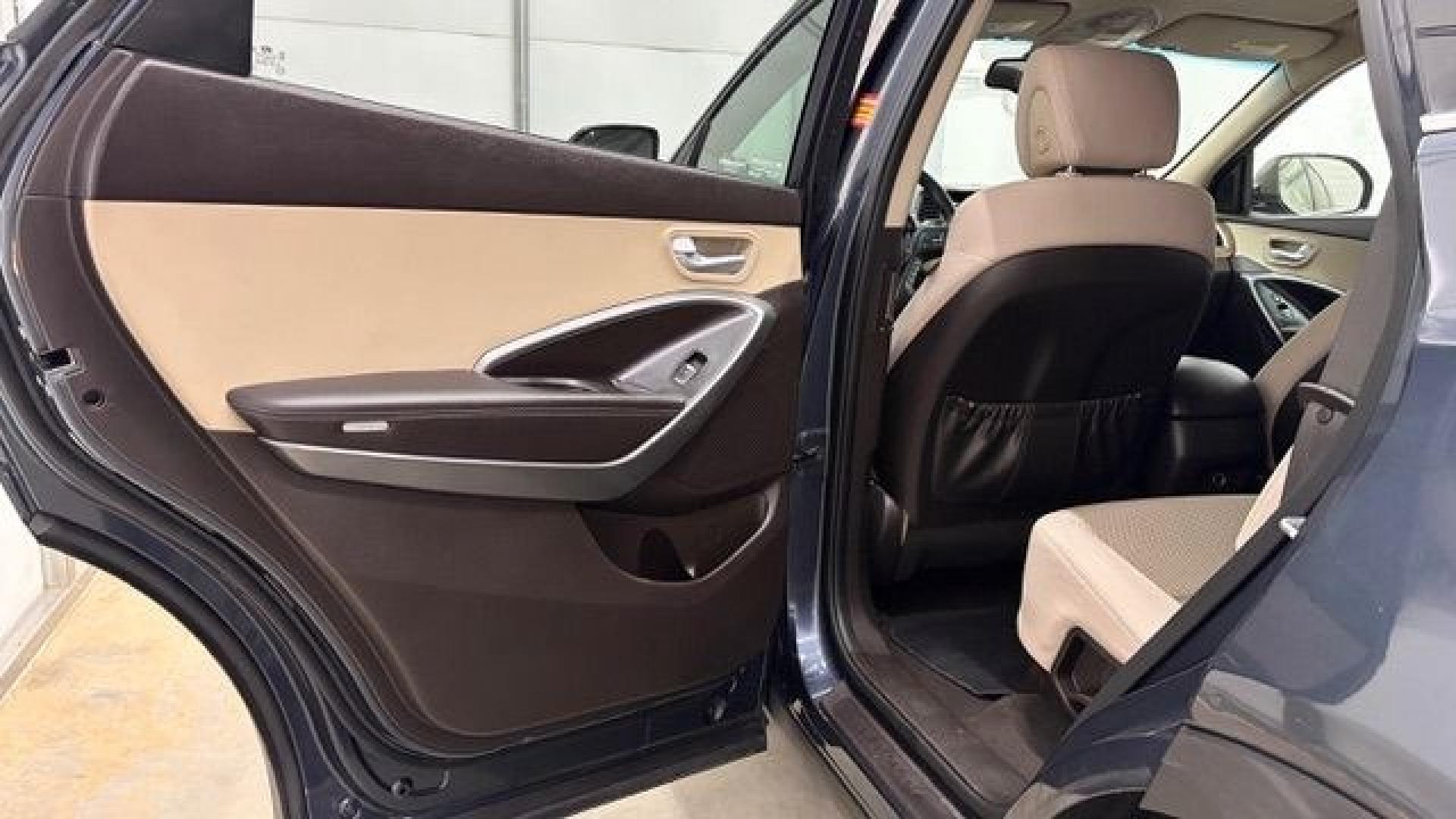 2016 Blue Hyundai Santa Fe SE AWD (KM8SMDHF4GU) with an 3.3L V6 DOHC 24V engine, 6-Speed Automatic transmission, located at 1806 Veterans Memorial Hwy SW, Austell, GA, 30168, (770) 944-9558, 33.817959, -84.606987 - This Santa Fe is in great shape overall. The exterior looks good with only minor scratches, and the tires look brand new. Inside, the seating is very comfortable. A roomy, practical SUV that's ready for daily driving.- Photo#14