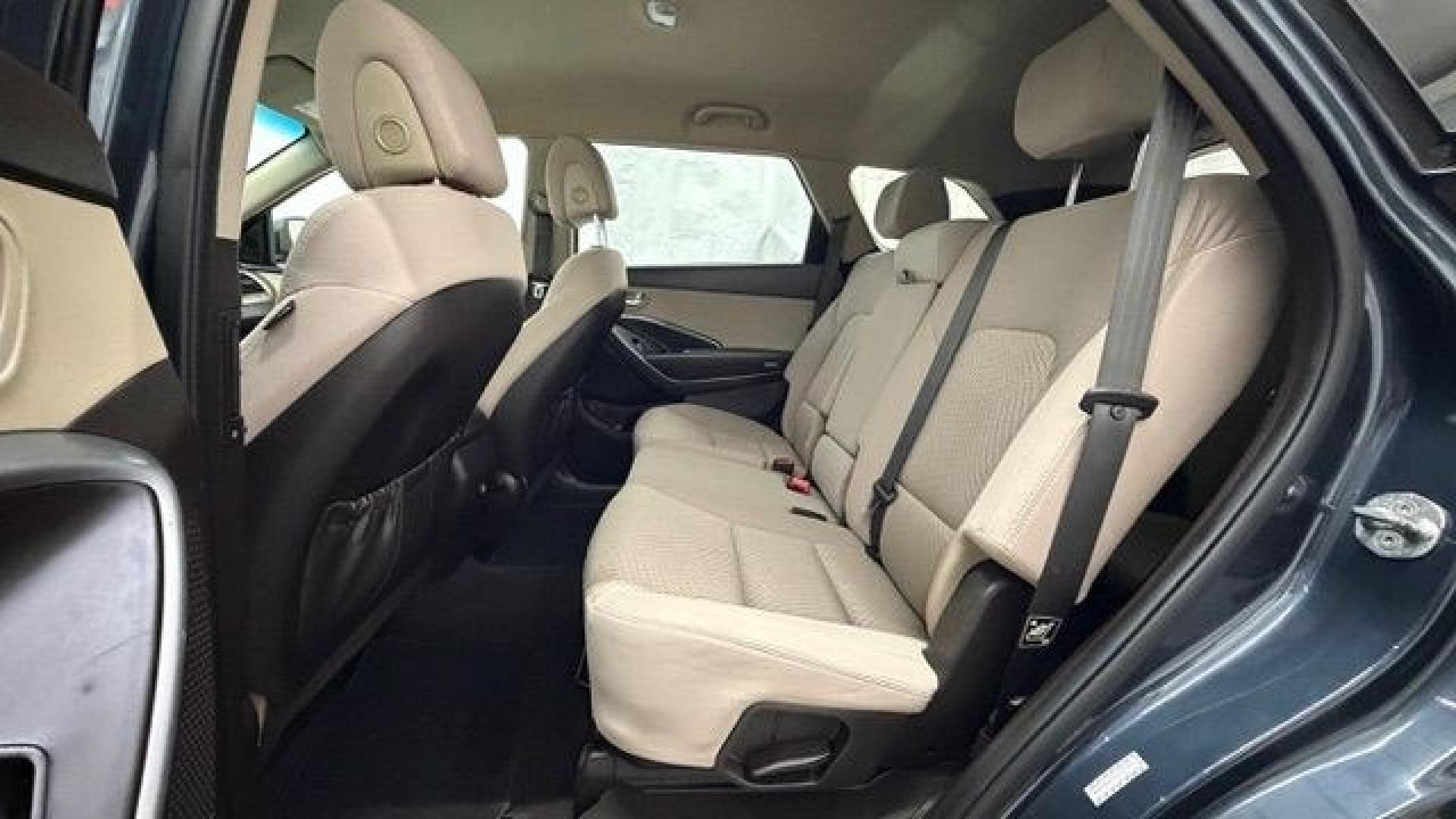 2016 Blue Hyundai Santa Fe SE AWD (KM8SMDHF4GU) with an 3.3L V6 DOHC 24V engine, 6-Speed Automatic transmission, located at 1806 Veterans Memorial Hwy SW, Austell, GA, 30168, (770) 944-9558, 33.817959, -84.606987 - This Santa Fe is in great shape overall. The exterior looks good with only minor scratches, and the tires look brand new. Inside, the seating is very comfortable. A roomy, practical SUV that's ready for daily driving.- Photo#15