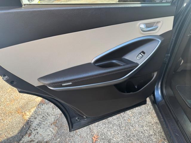 2016 Blue Hyundai Santa Fe SE AWD (KM8SMDHF4GU) with an 3.3L V6 DOHC 24V engine, 6-Speed Automatic transmission, located at 1806 Veterans Memorial Hwy SW, Austell, GA, 30168, (770) 944-9558, 33.817959, -84.606987 - Photo#9