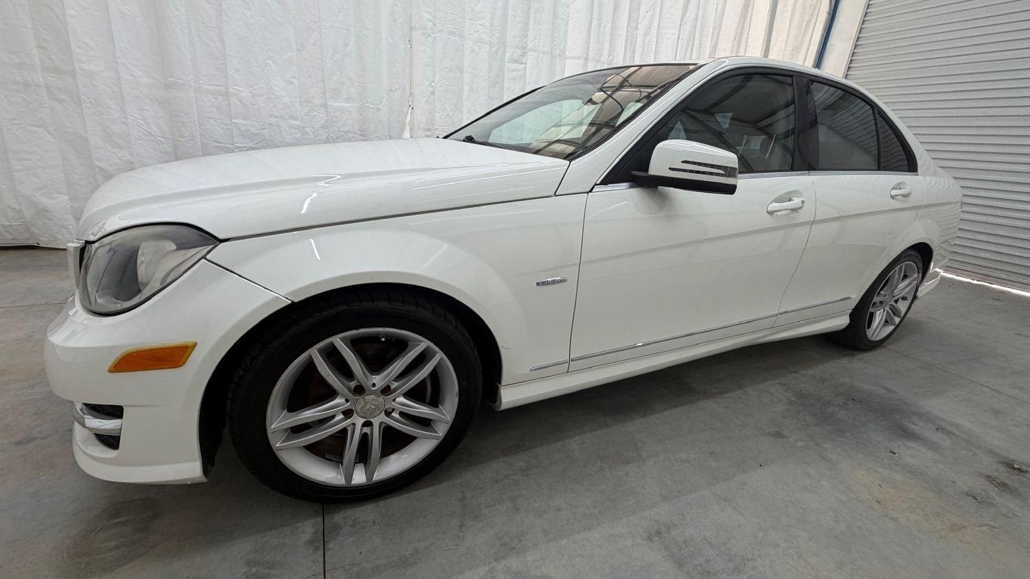 2012 White Mercedes Benz C Class C250 (WDDGF4HB1CR) with an 1.8L I-4 DI T/C I/C engine, located at 1806 Veterans Memorial Hwy SW, Austell, GA, 30168, (770) 944-9558, 33.817959, -84.606987 - Save money while riding with class in this Mercedes. The overall paint is good, with a couple of paint scrapes on the passenger door. The tires are in good condition, and the interior is in good shape; this is a non-smoking vehicle.- Photo#1