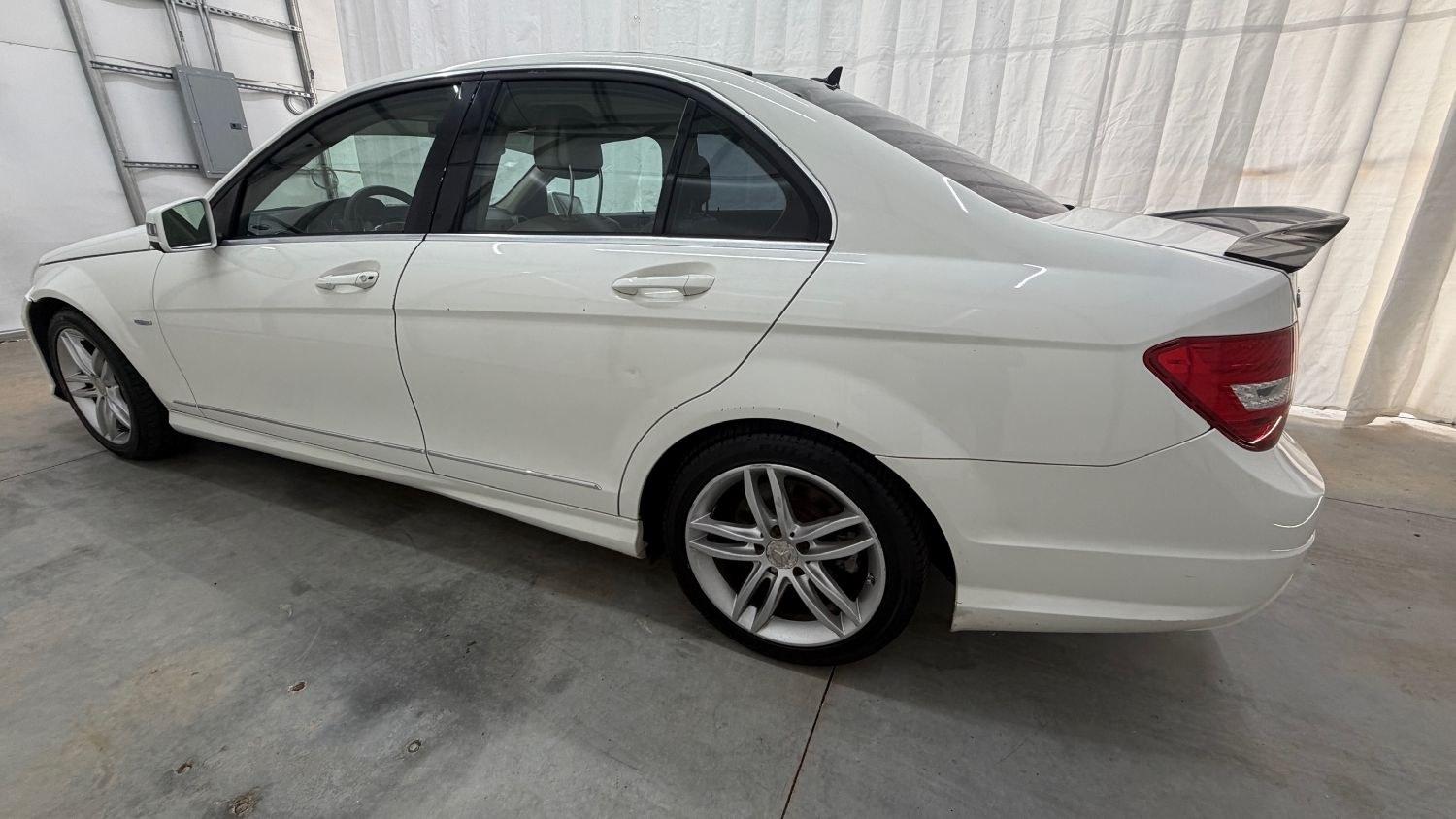 2012 White Mercedes Benz C Class C250 (WDDGF4HB1CR) with an 1.8L I-4 DI T/C I/C engine, located at 1806 Veterans Memorial Hwy SW, Austell, GA, 30168, (770) 944-9558, 33.817959, -84.606987 - Save money while riding with class in this Mercedes. The overall paint is good, with a couple of paint scrapes on the passenger door. The tires are in good condition, and the interior is in good shape; this is a non-smoking vehicle.- Photo#2