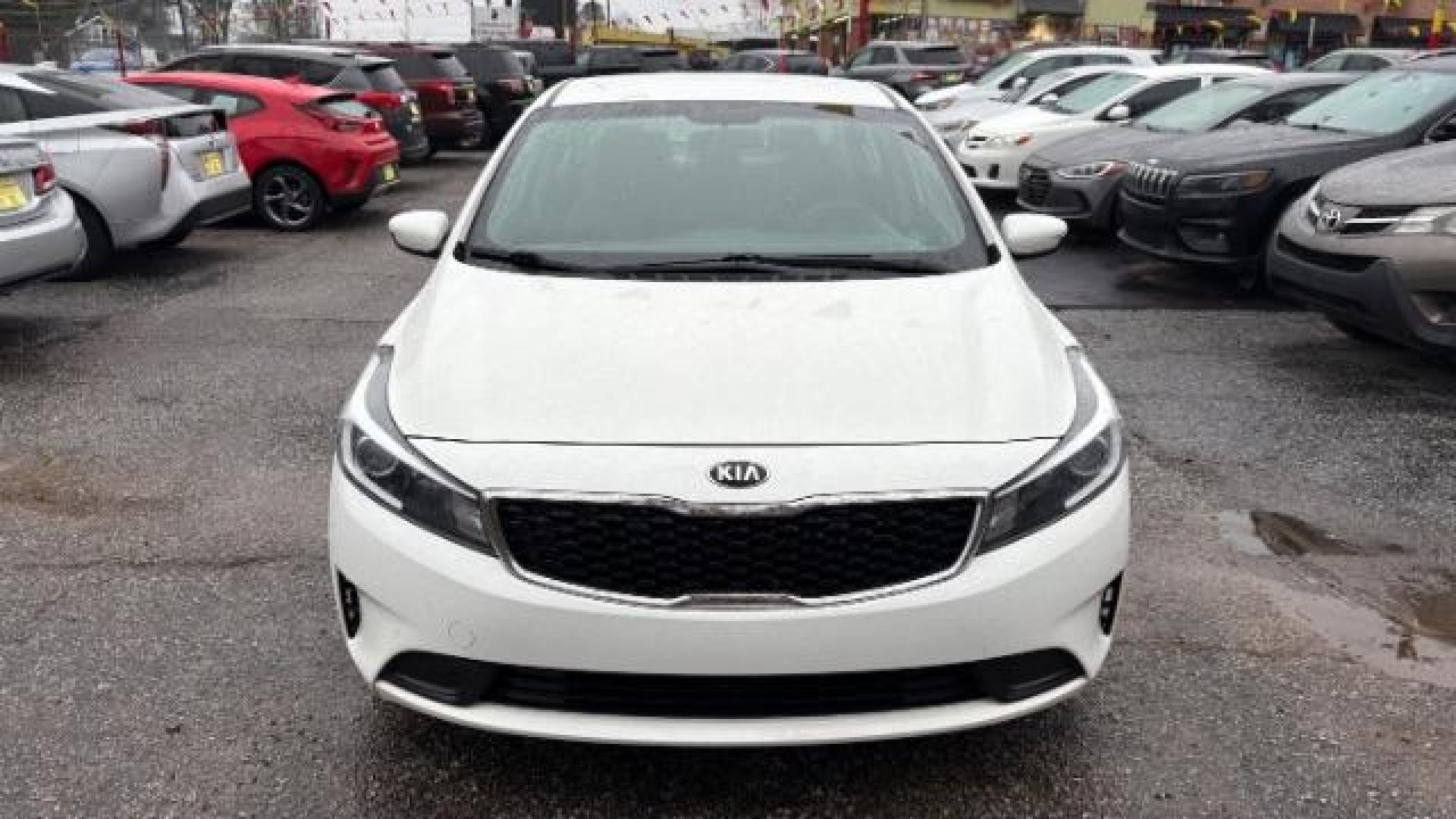2017 White Kia Forte LX 6A (3KPFK4A78HE) with an 2.0L L4 DOHC 16V engine, 6-Speed Automatic transmission, located at 1806 Veterans Memorial Hwy SW, Austell, GA, 30168, (770) 944-9558, 33.817959, -84.606987 - Photo#0