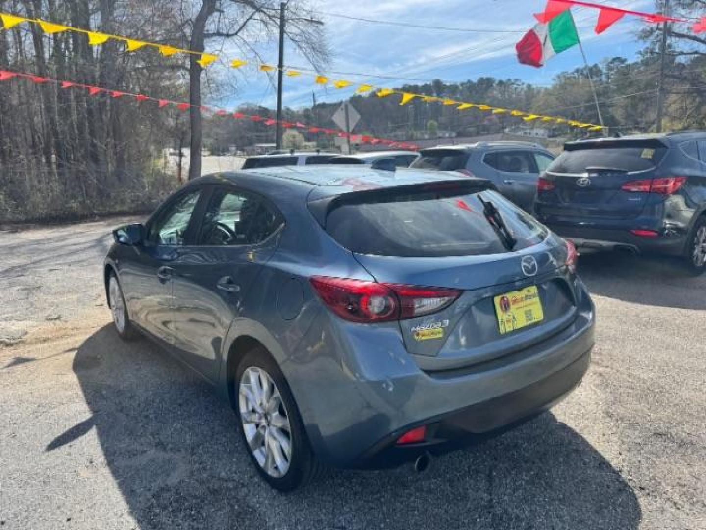 2014 Blue Mazda Mazda3 Hatchback s Touring (JM1BM1L3XE1) with an SKYACTIV-G 2.5L I-4 gasoline direct injection engine, located at 1806 Veterans Memorial Hwy SW, Austell, GA, 30168, (770) 944-9558, 33.817959, -84.606987 - Photo#4