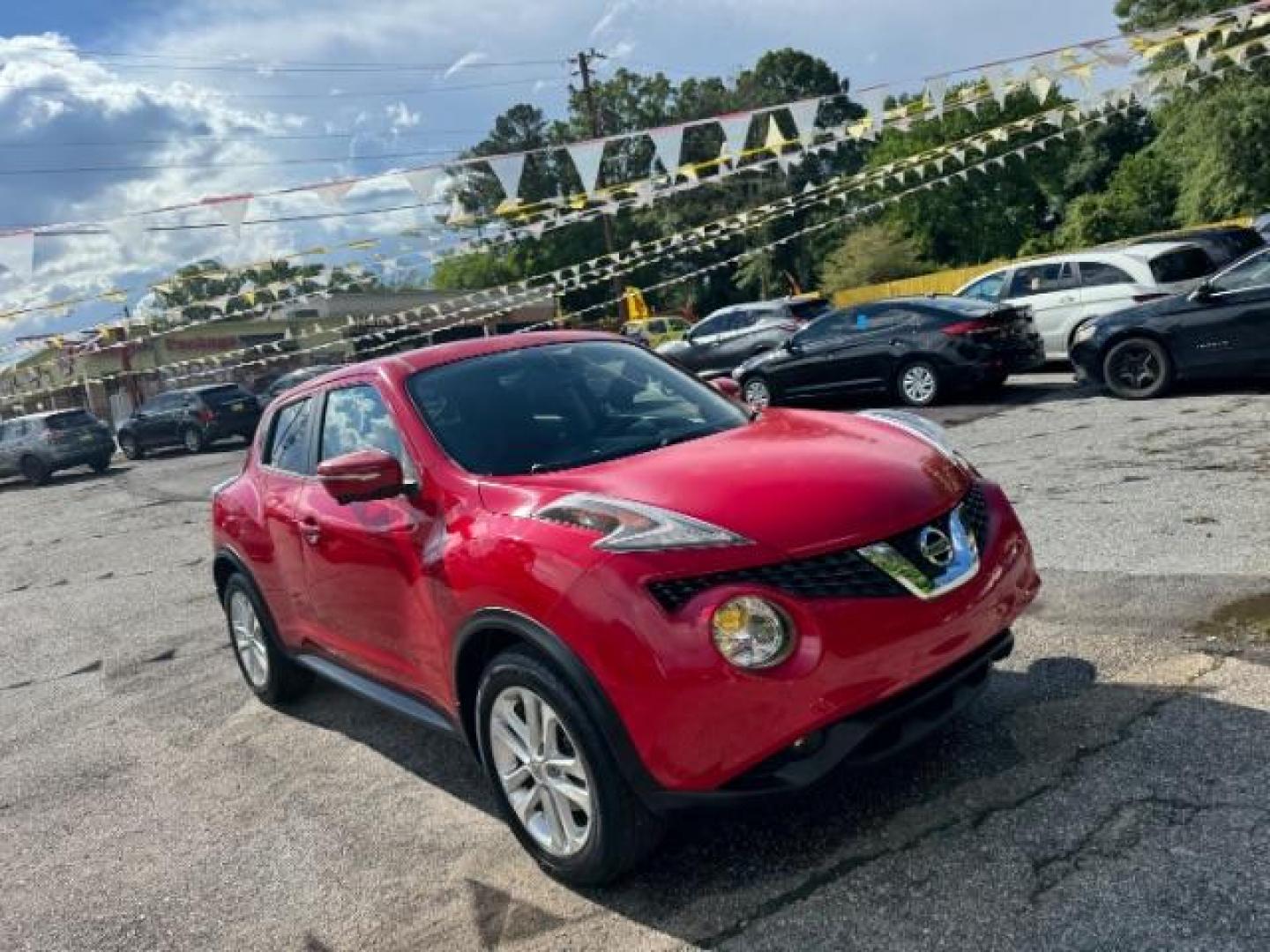 2015 Red Nissan Juke SV (JN8AF5MR5FT) with an 1.6L I-4 gasoline direct injection engine, located at 1806 Veterans Memorial Hwy SW, Austell, GA, 30168, (770) 944-9558, 33.817959, -84.606987 - Photo#2