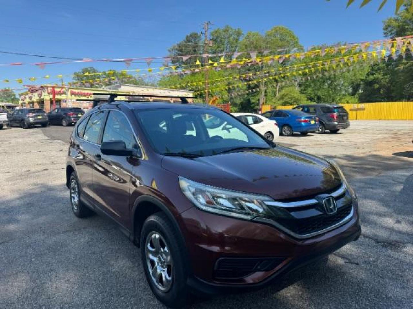 2015 Brown Honda CR-V LX (2HKRM3H39FH) with an 2.4L I-4 gasoline direct injection engine, located at 1806 Veterans Memorial Hwy SW, Austell, GA, 30168, (770) 944-9558, 33.817959, -84.606987 - Photo#2