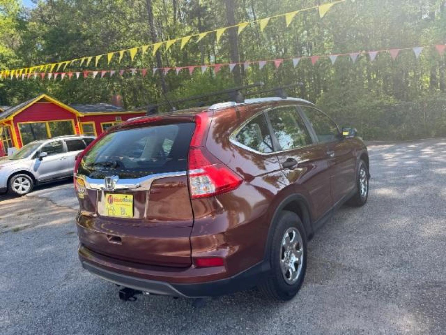 2015 Brown Honda CR-V LX (2HKRM3H39FH) with an 2.4L I-4 gasoline direct injection engine, located at 1806 Veterans Memorial Hwy SW, Austell, GA, 30168, (770) 944-9558, 33.817959, -84.606987 - Photo#3