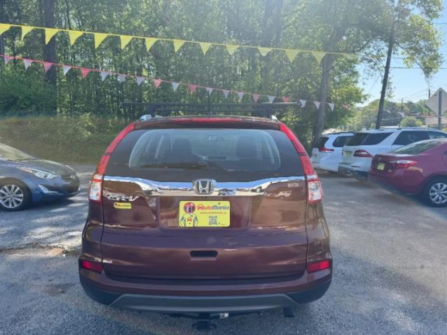 2015 Brown Honda CR-V LX (2HKRM3H39FH) with an 2.4L I-4 gasoline direct injection engine, located at 1806 Veterans Memorial Hwy SW, Austell, GA, 30168, (770) 944-9558, 33.817959, -84.606987 - Photo#4