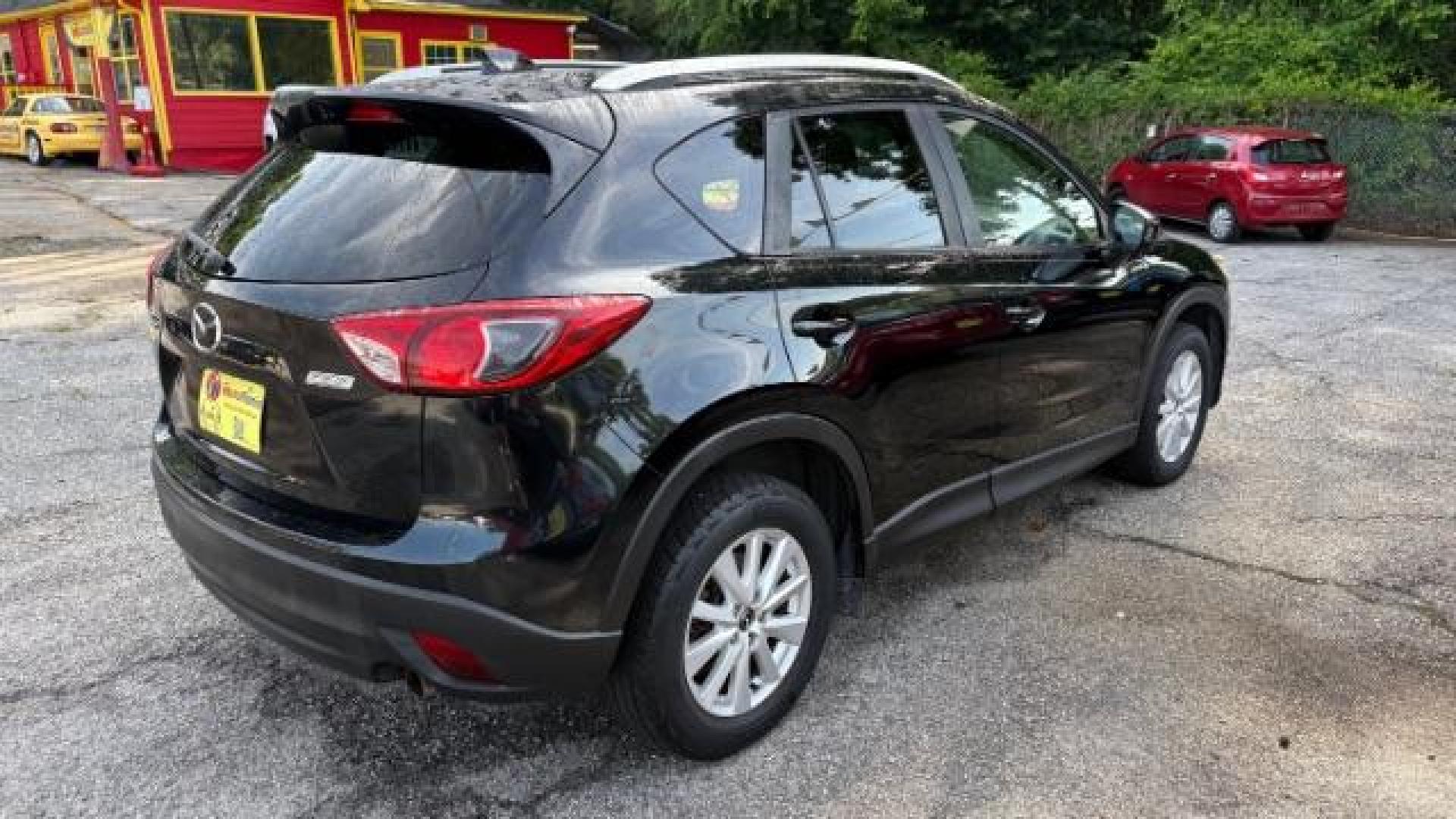 2014 Black Mazda CX-5 Touring (JM3KE2CY7E0) with an SKYACTIV-G 2.5L I-4 gasoline direct injection engine, located at 1806 Veterans Memorial Hwy SW, Austell, GA, 30168, (770) 944-9558, 33.817959, -84.606987 - Photo#3