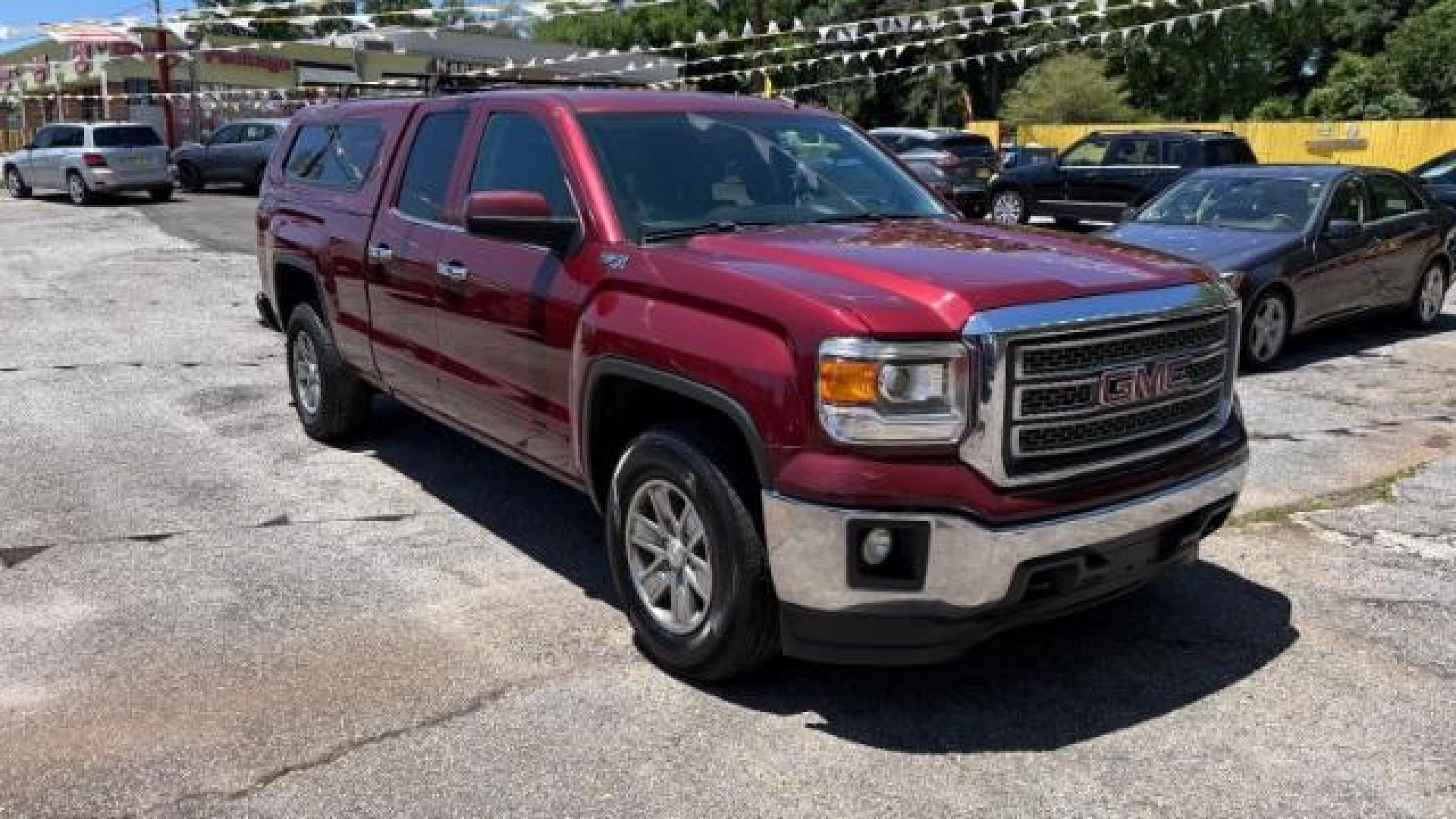 2014 Maroon GMC Sierra 1500 SLE (1GTV2UEC4EZ) with an EcoTec3 5.3L V-8 gasoline direct injection engine, Automatic transmission, located at 1806 Veterans Memorial Hwy SW, Austell, GA, 30168, (770) 944-9558, 33.817959, -84.606987 - Photo#2