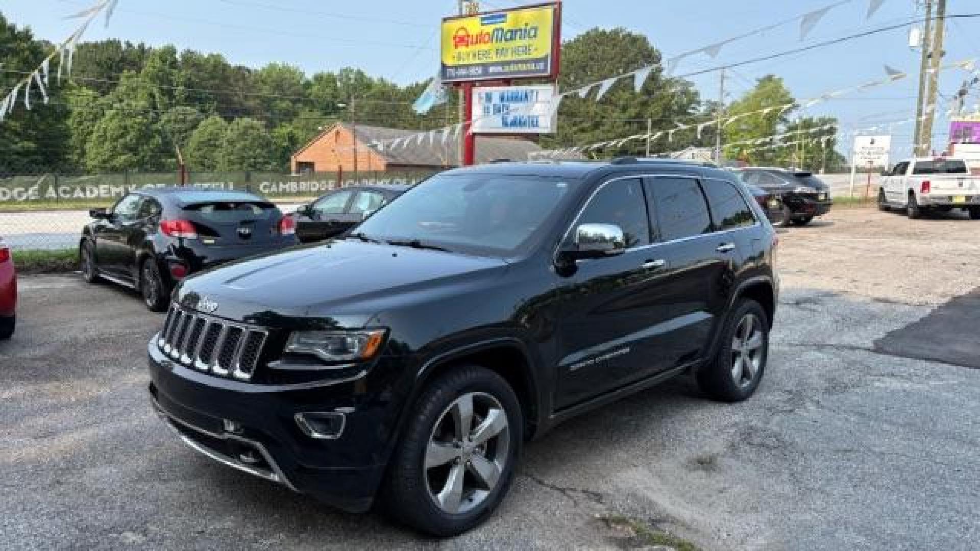 2014 Green Jeep Grand Cherokee Overland (1C4RJECG5EC) with an 3.6L V-6 DOHC engine, located at 1806 Veterans Memorial Hwy SW, Austell, GA, 30168, (770) 944-9558, 33.817959, -84.606987 - Photo#0