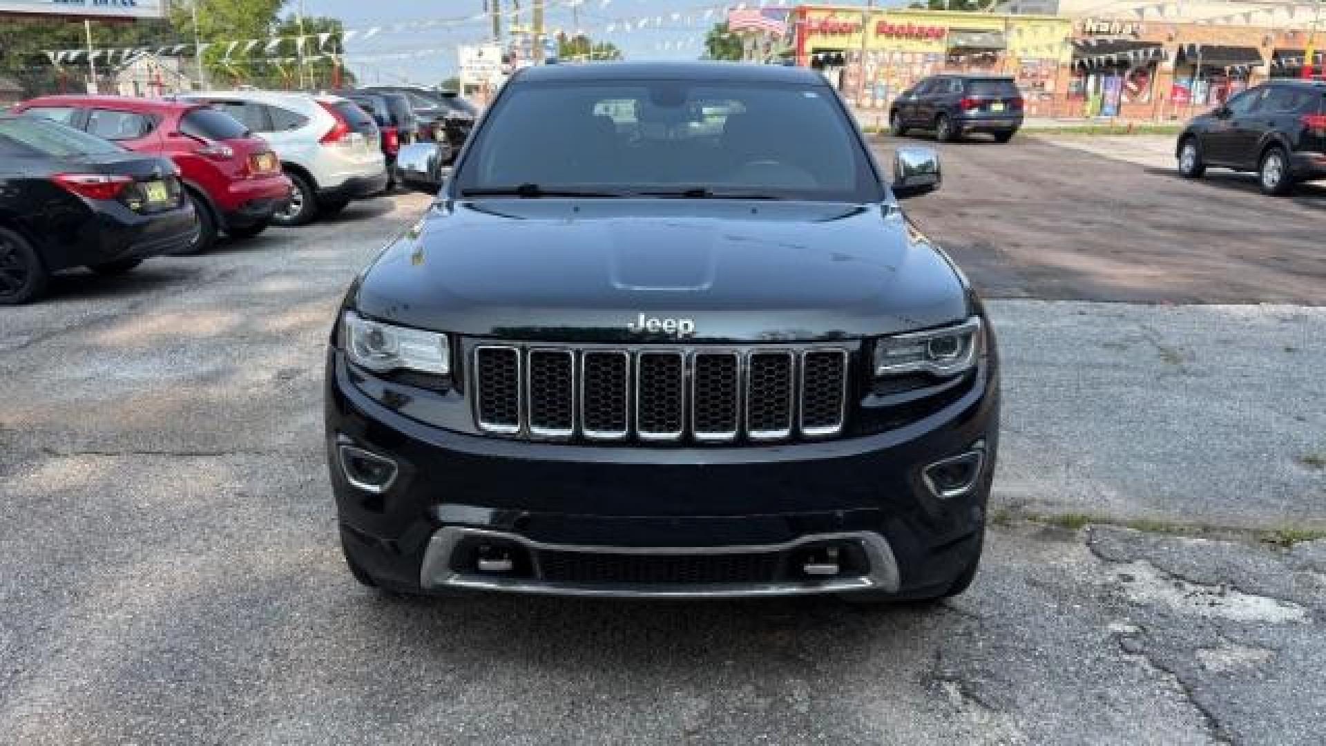 2014 Green Jeep Grand Cherokee Overland (1C4RJECG5EC) with an 3.6L V-6 DOHC engine, located at 1806 Veterans Memorial Hwy SW, Austell, GA, 30168, (770) 944-9558, 33.817959, -84.606987 - Photo#1