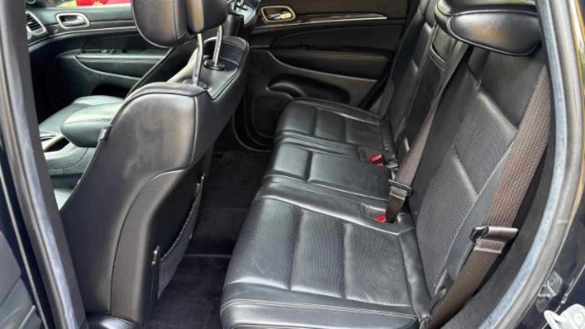 2014 Green Jeep Grand Cherokee Overland (1C4RJECG5EC) with an 3.6L V-6 DOHC engine, located at 1806 Veterans Memorial Hwy SW, Austell, GA, 30168, (770) 944-9558, 33.817959, -84.606987 - Photo#7